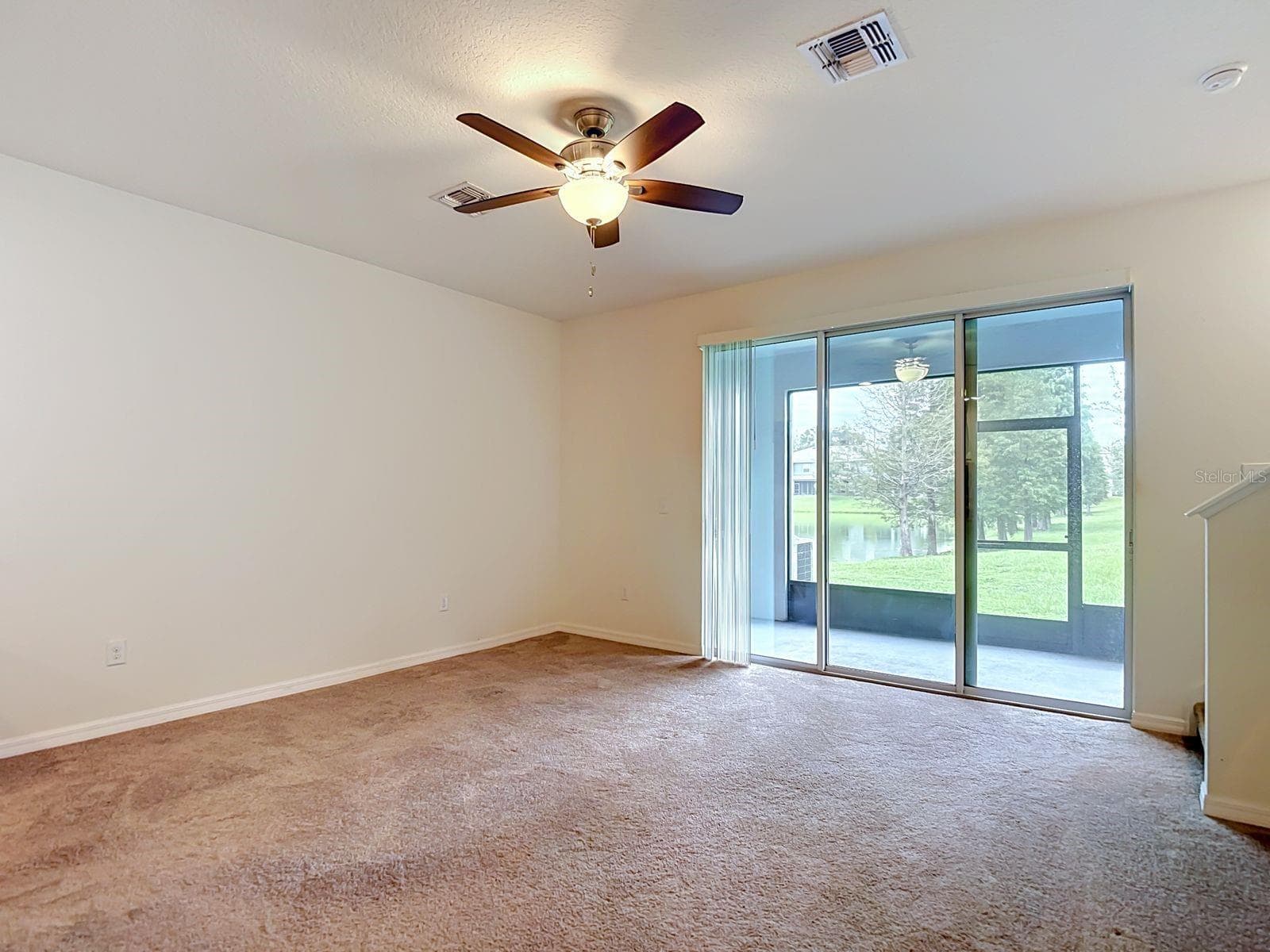 Living area with triple sliding doors to the lanai - 3328 PLEASANT WILLOW CT, BRANDON