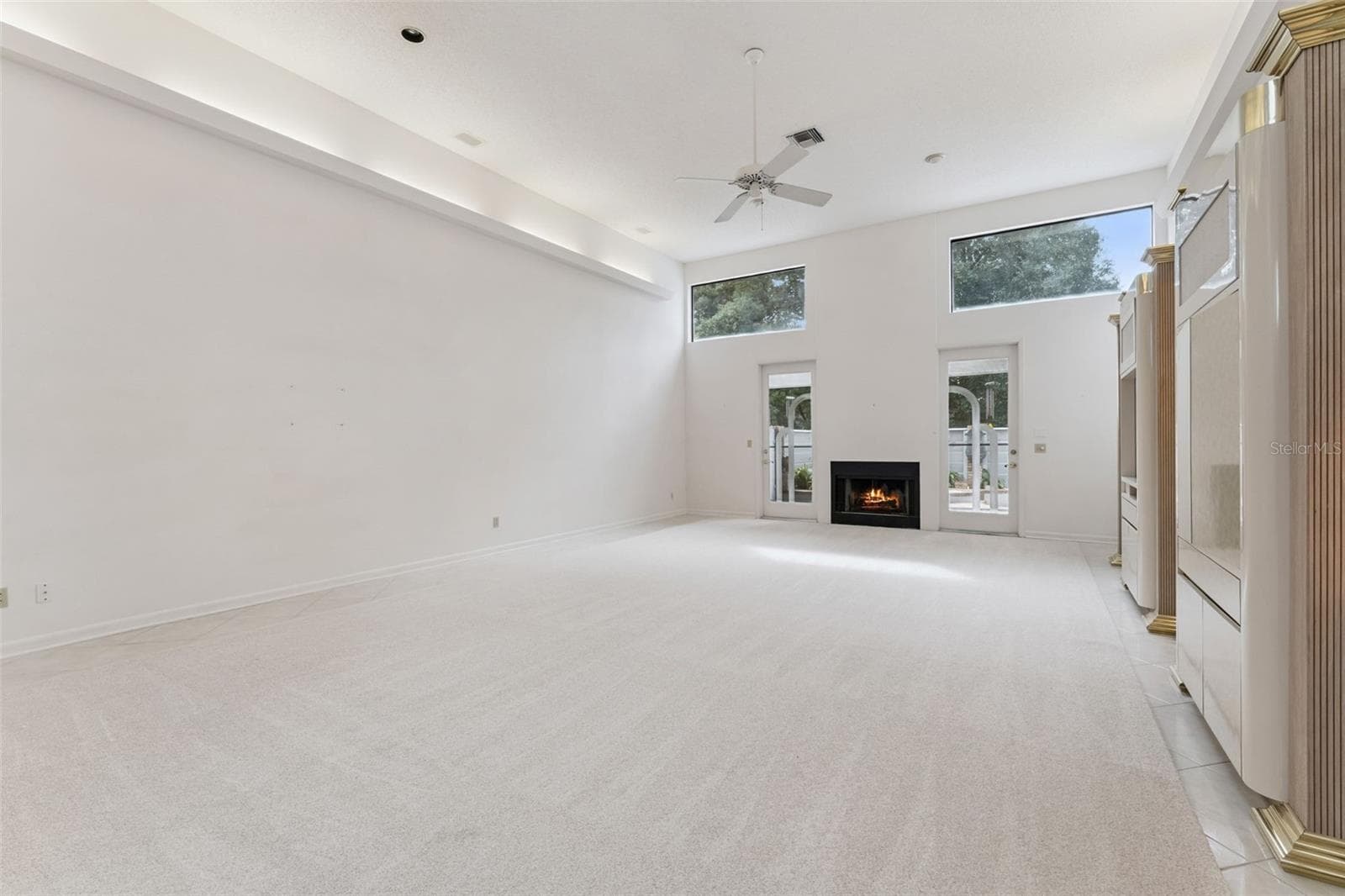 Living and dining room with wood burning fire place - 221 PINE CONE LN, LONGWOOD