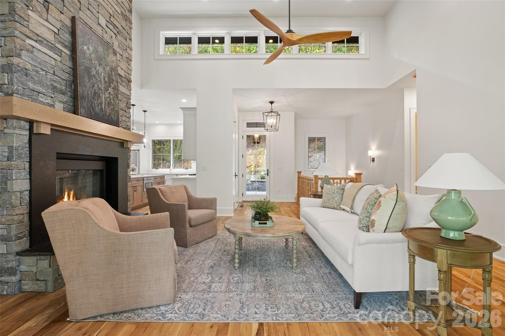 Inviting living room with see-through natural stone fireplace - 505 Barrington Drive, Asheville