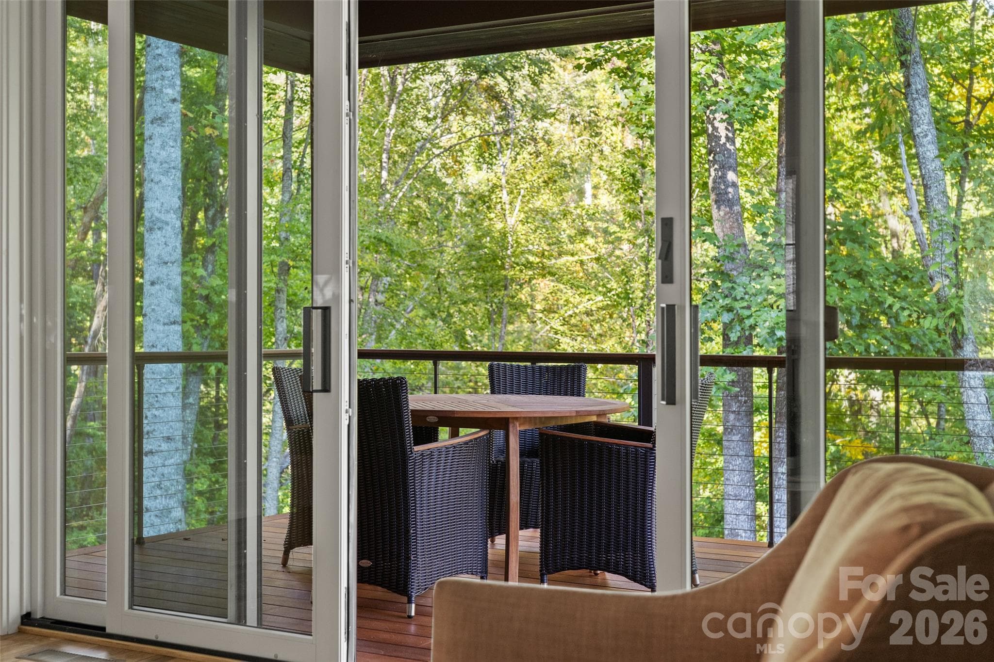 Glass sliding doors from main level living room flows to covered deck - 505 Barrington Drive, Asheville