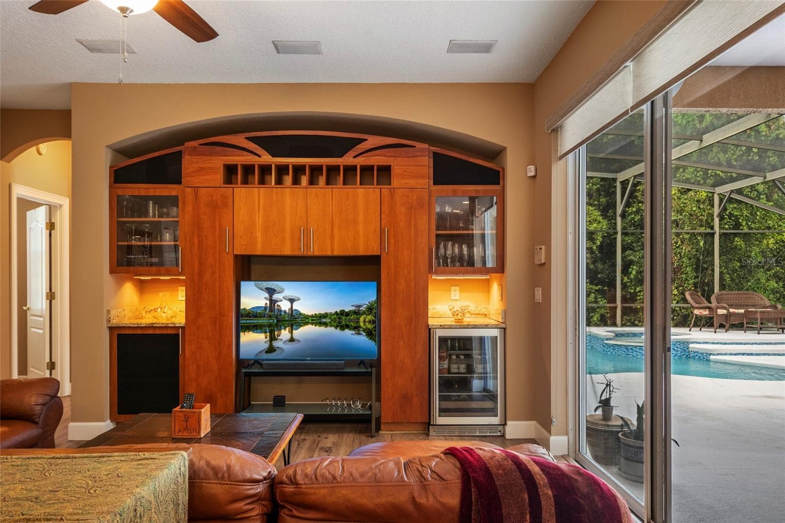 Custom Built In Entertainment Center to coordinate with kitchen cabinetry featuring a mini bar and fridge. - 2712 ALOMA OAKS DR, OVIEDO