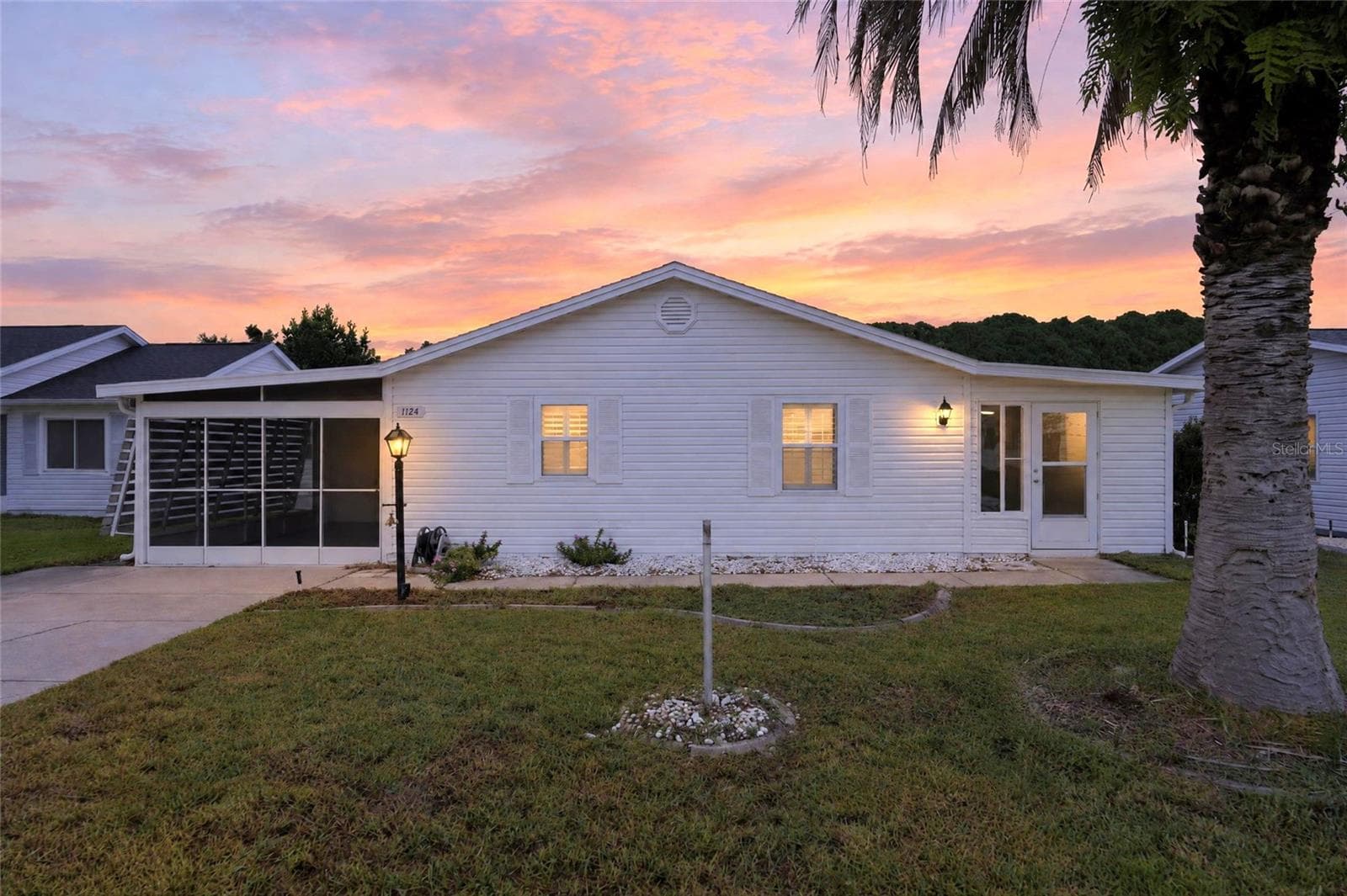 Front Exterior at Dusk (Virtual Twilight, digitally enhanced) - 1124 DEL TORO DR, LADY LAKE