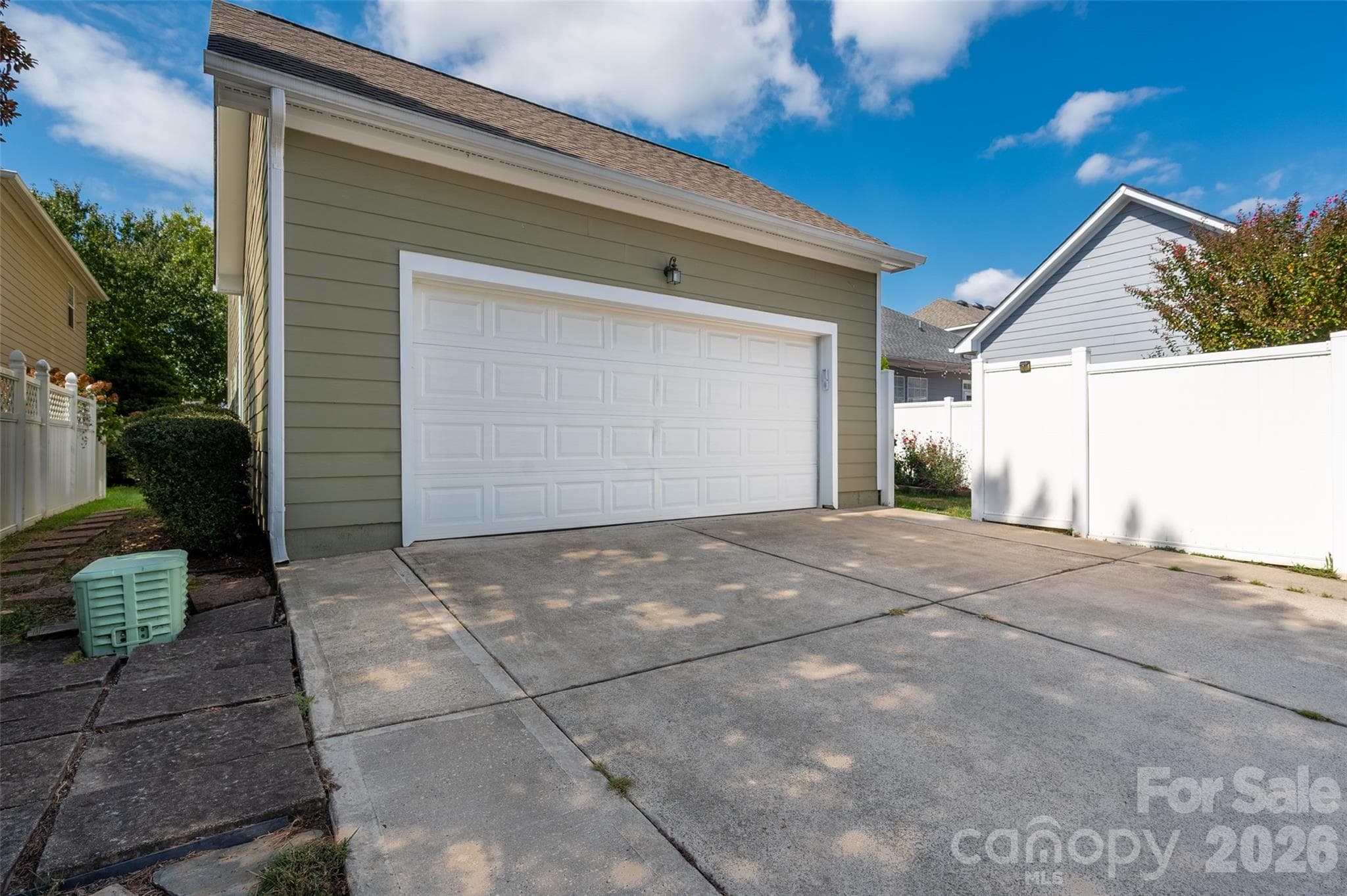 Rear facing 2 car garage with driveway space for several cars. - 3004 Ivy Brook Place, Matthews