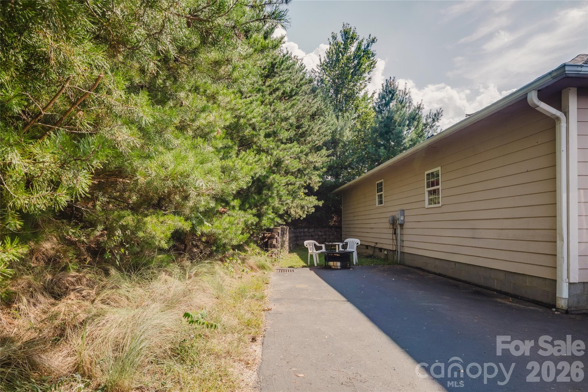 Extra parking or patio space to the left of the garage - 91 Crestview Street, Canton