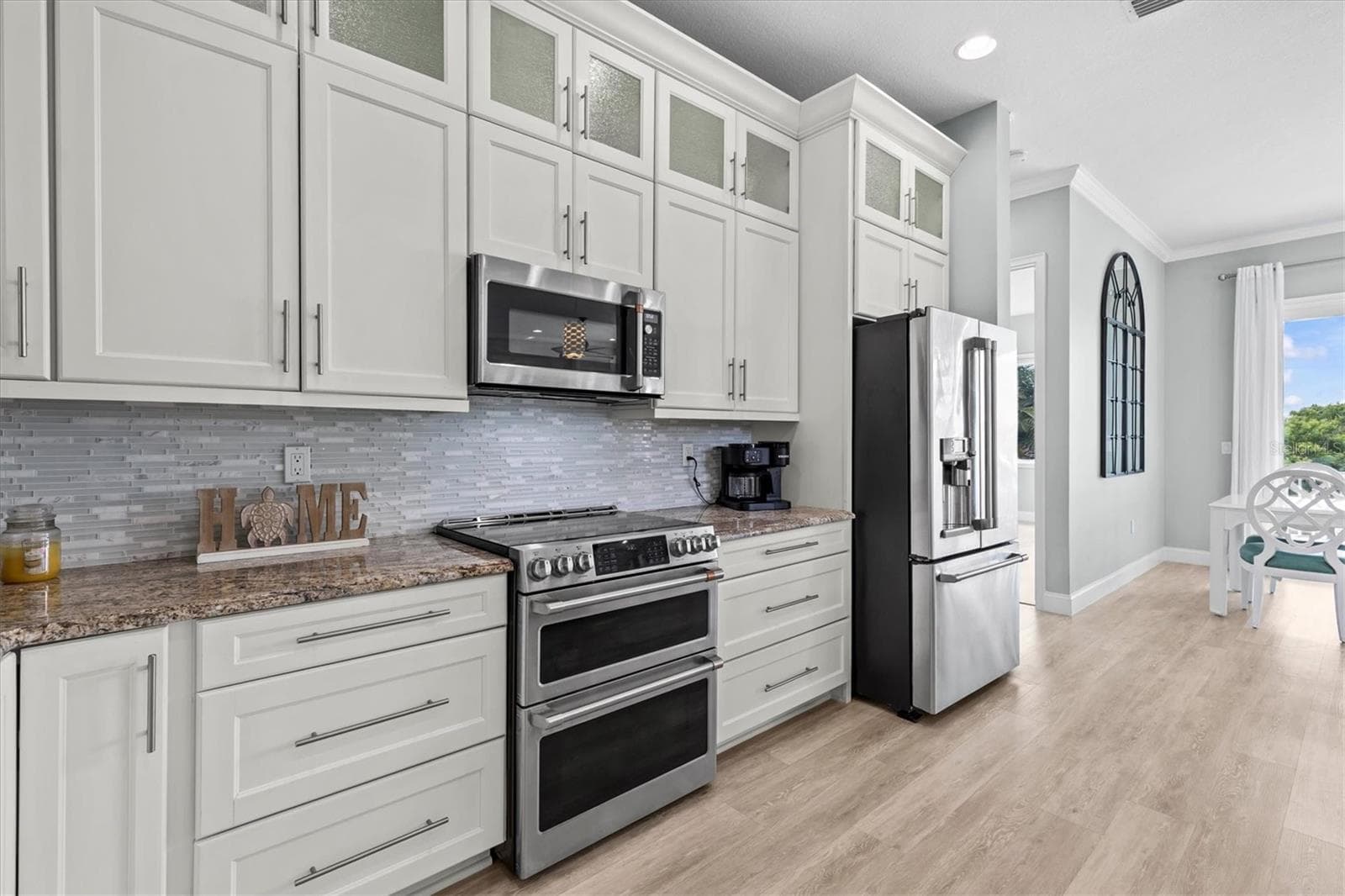 White Shaker Cabinets top Cabinets with Glass Doors - 4030 GULF COAST DR, HERNANDO BEACH