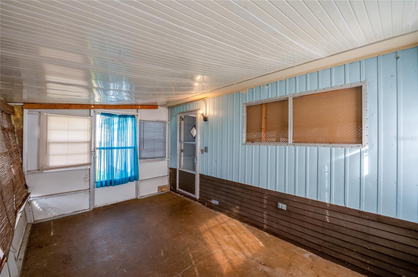 Another view showcases the porch’s generous proportions and direct access to the home, offering additional space for relaxing or casual use. - 128 KON TIKI TER, PORT ORANGE