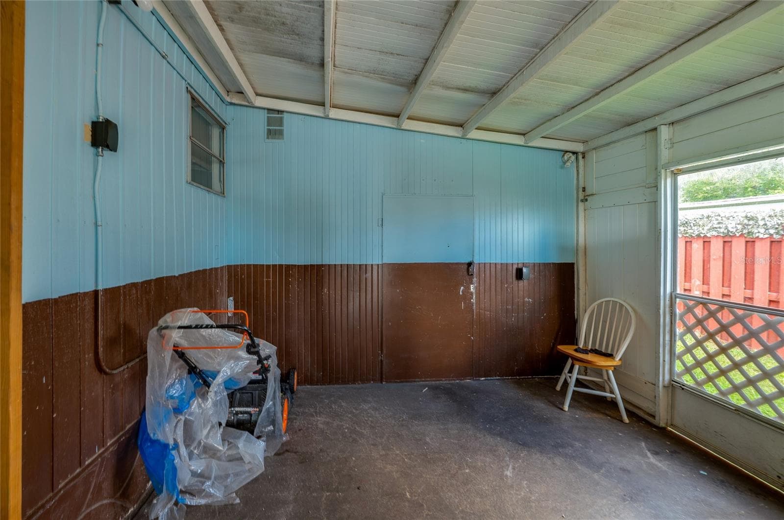 Additional view highlights the covered space and open side access, offering flexible room for outdoor seating, storage, or other uses. - 128 KON TIKI TER, PORT ORANGE