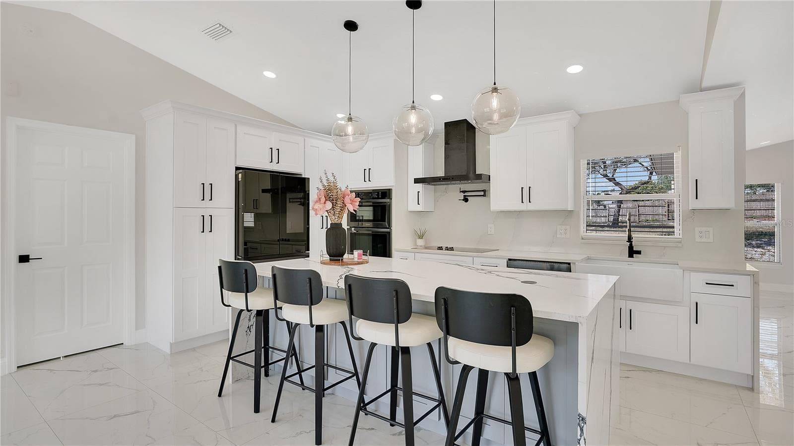 Kitchen with center island and bar seating - 2685 GROVELAND AVE, DELTONA