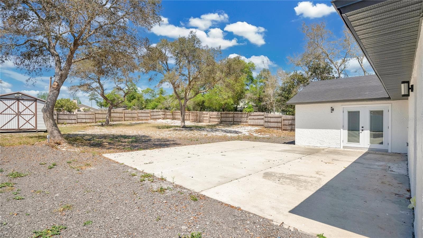 Back yard and rear elevation - 2685 GROVELAND AVE, DELTONA