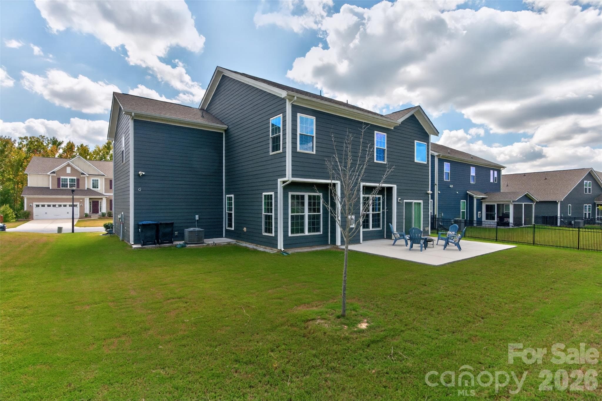 View of home and extended patio from the rear yard. - 4638 Monument Valley Drive, Indian Land