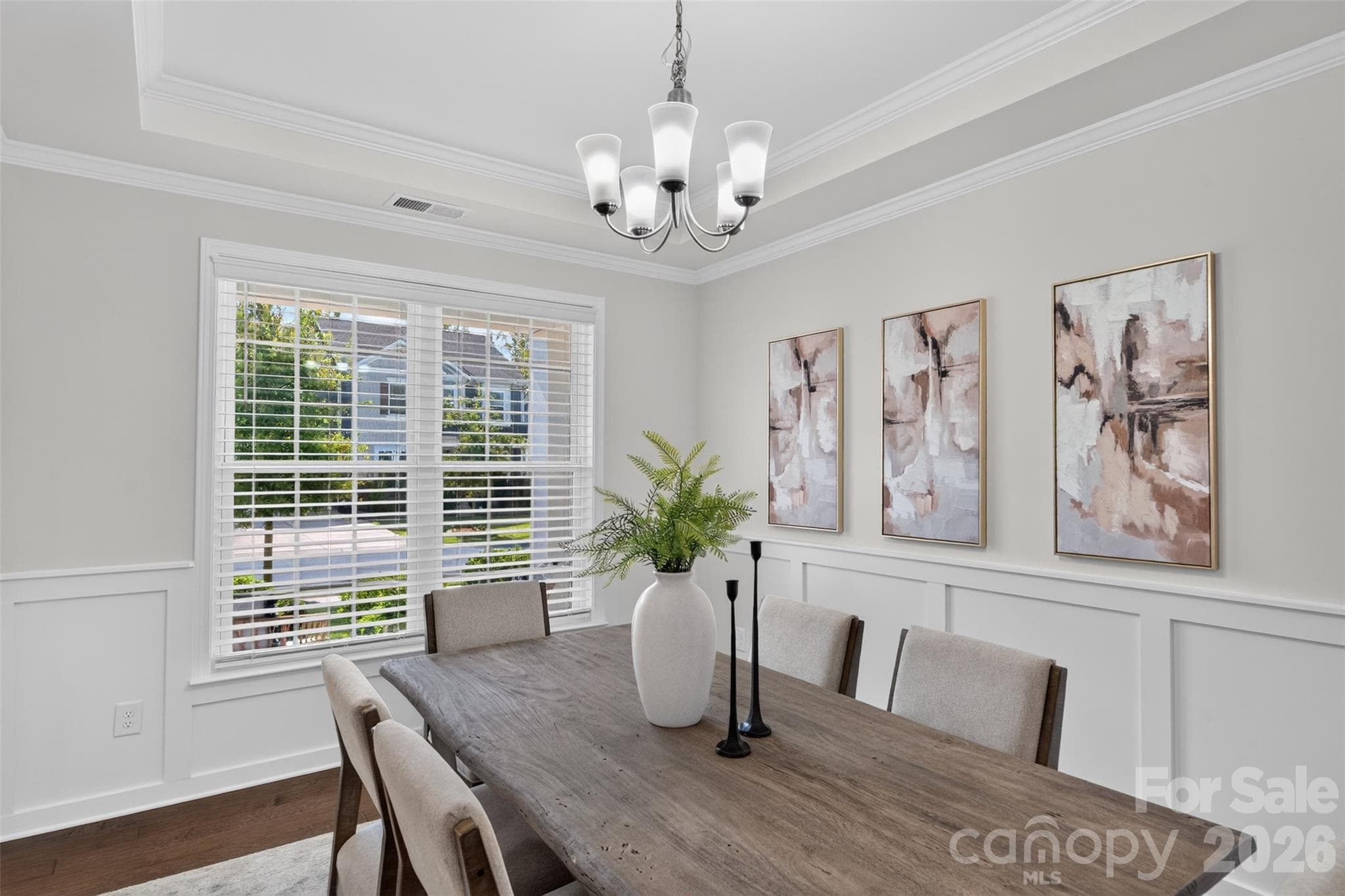 Formal dining room with modern woodworking and tray ceiling. - 4638 Monument Valley Drive, Indian Land
