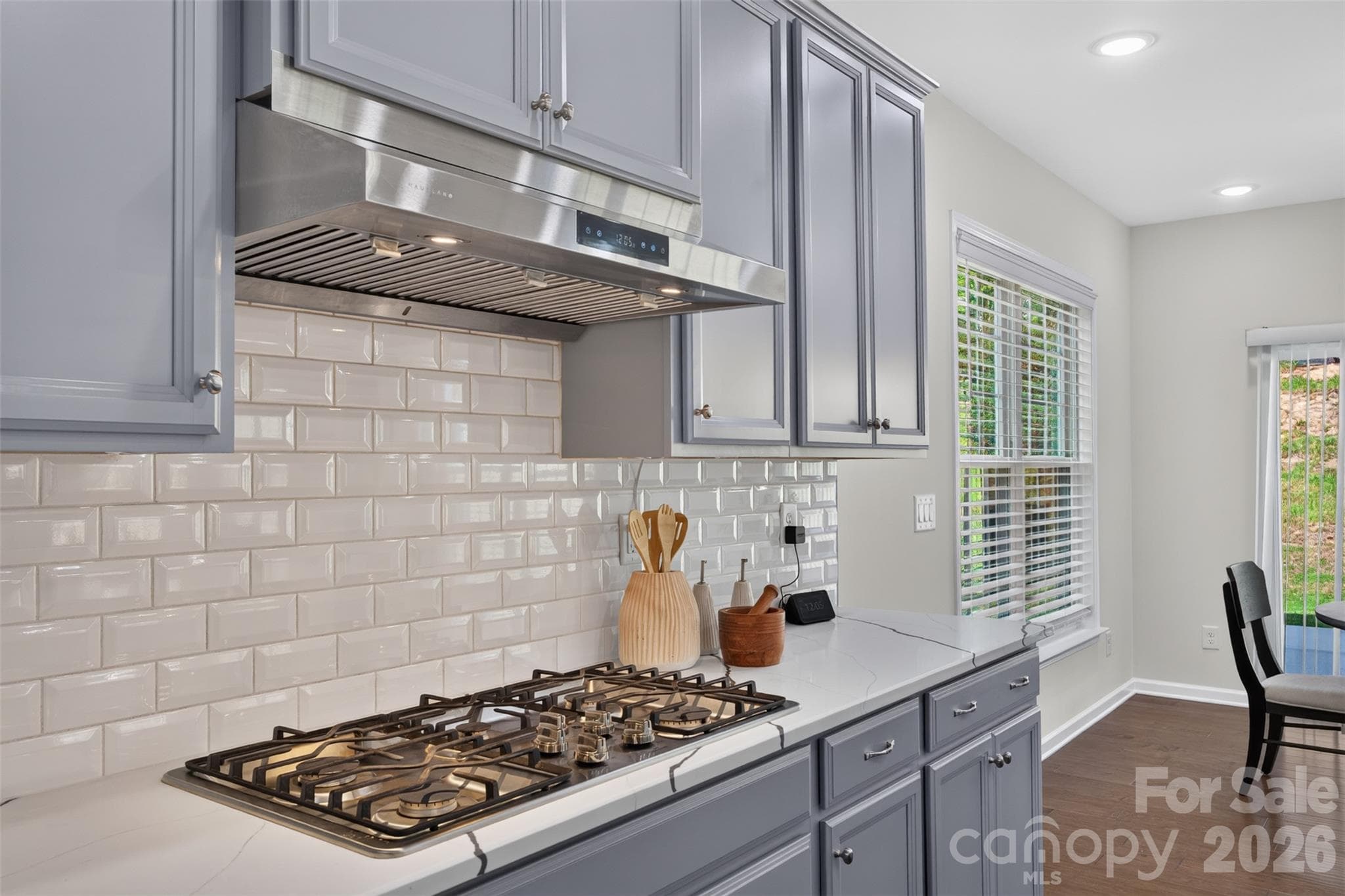 Beautiful tile backsplash and gas cooktop with vented hood. - 4638 Monument Valley Drive, Indian Land