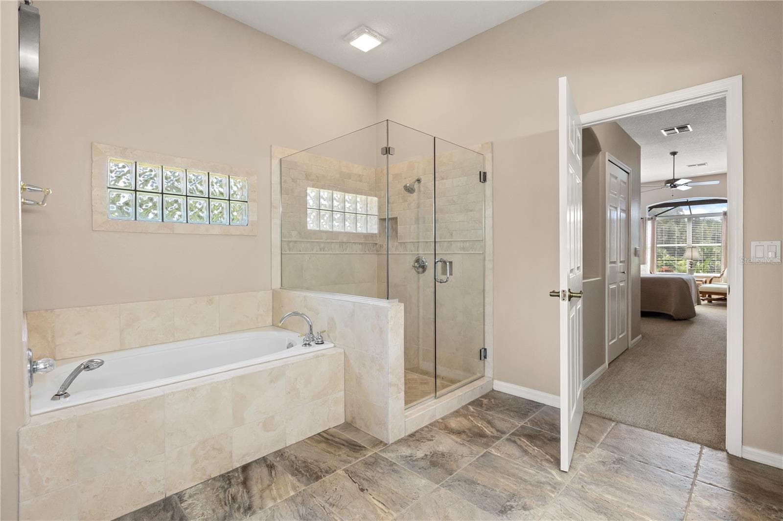Primary bathroom featuring double vanity sinks, soak in tub and shower - 2735 TETON STONE RUN, ORLANDO