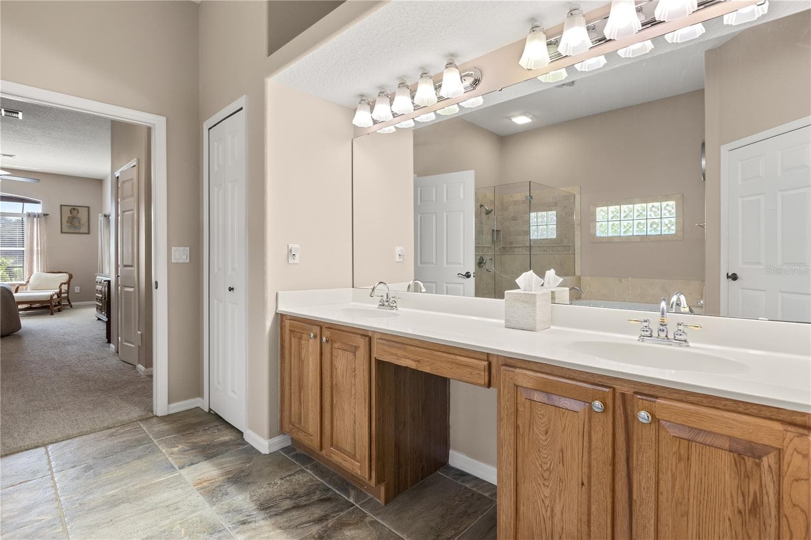 Primary bathroom featuring double vanity sinks, soak in tub and shower - 2735 TETON STONE RUN, ORLANDO
