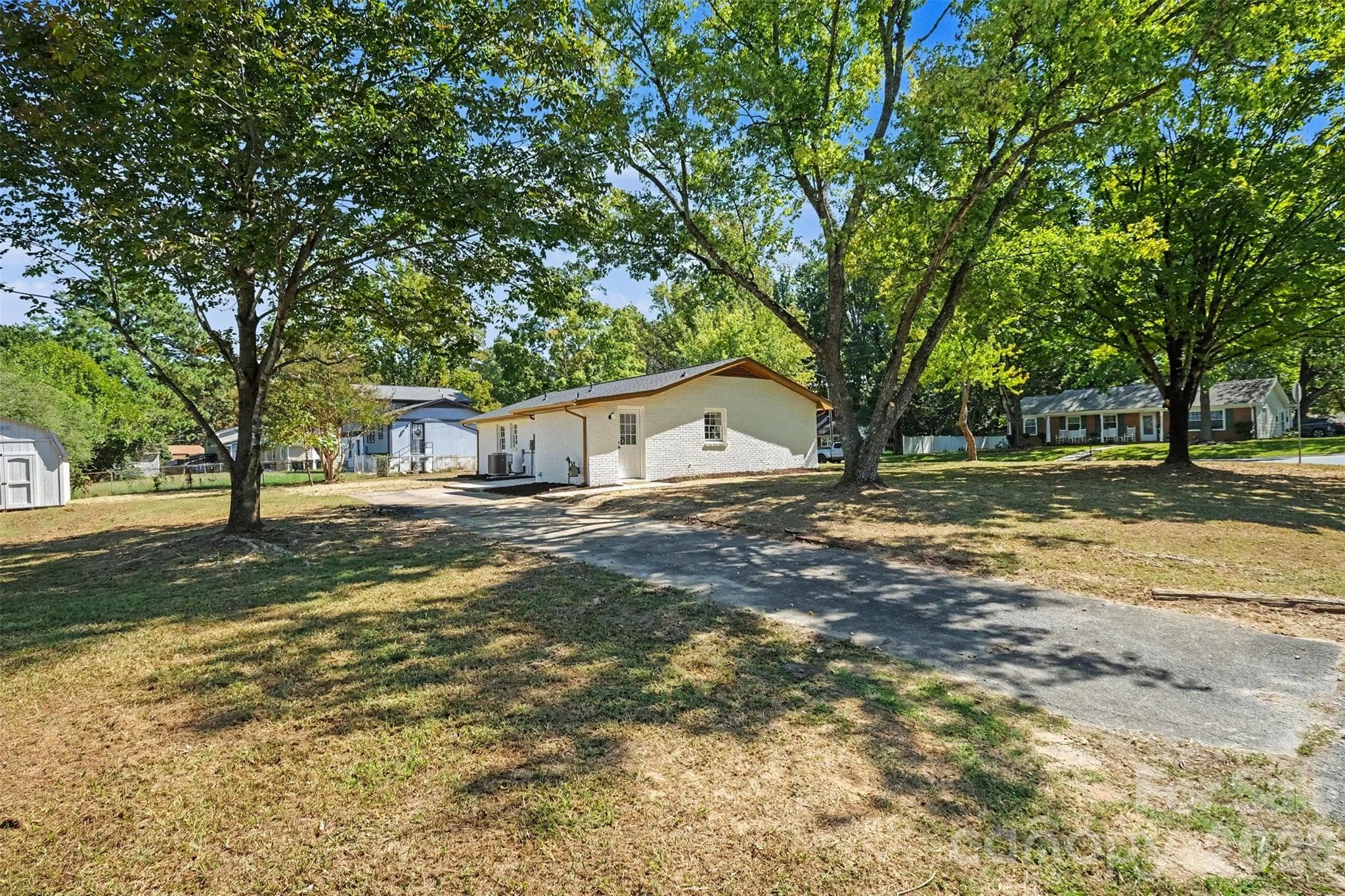 Spacious side driveway with ample parking space and mature trees. - 3801 Hillock Court, Charlotte