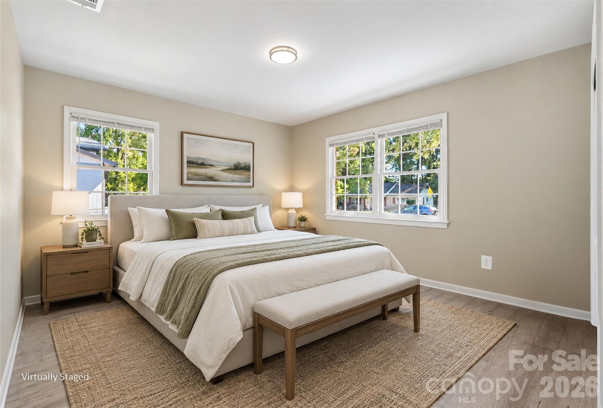 Spacious bedroom highlighted by double windows for ample natural light, fresh paint, and updated flooring. (Virtually Staged) - 3801 Hillock Court, Charlotte