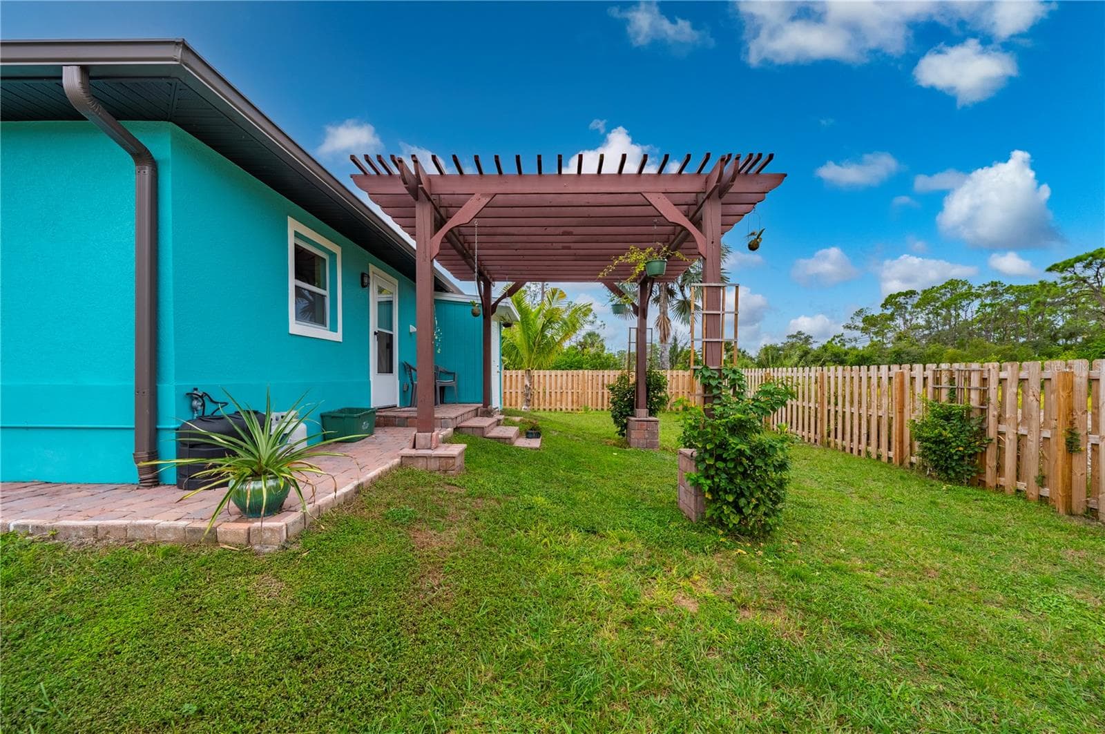 Sit on the brick paver patio under the pergola to watch colorful nightly SW Florida sunset shows! - 1027 CAMPBELL ST, PORT CHARLOTTE