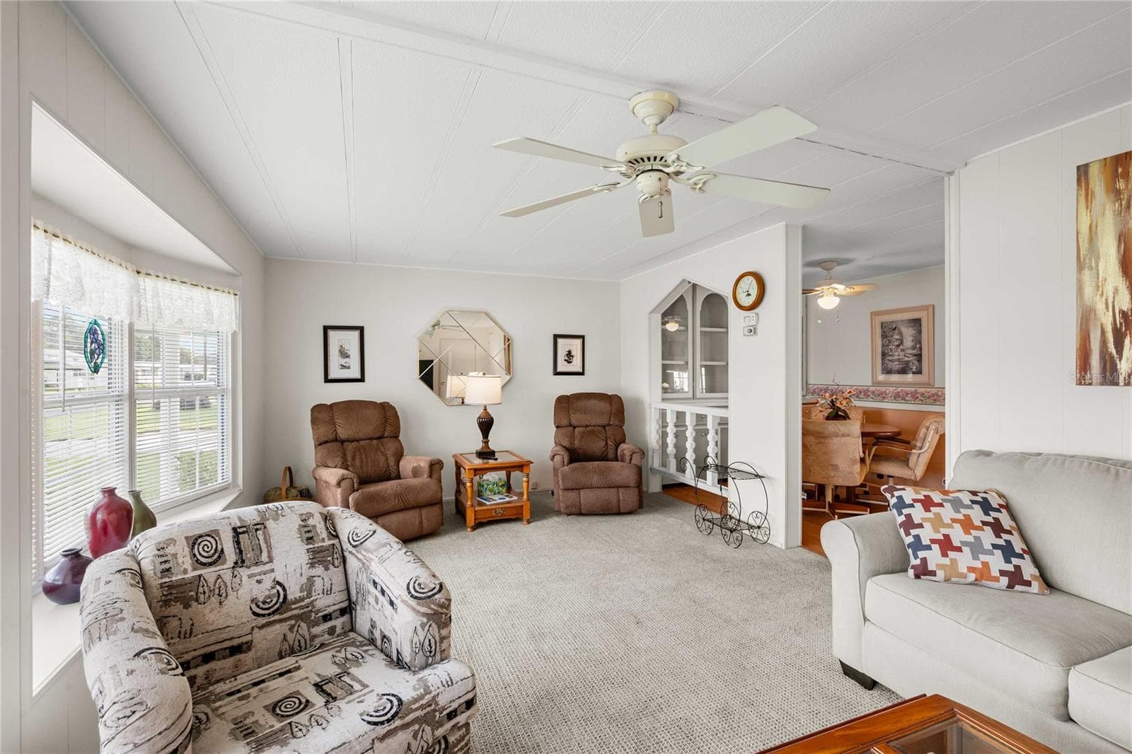 Living room has many double pane windows. - 5352 PLANT ST, ZEPHYRHILLS