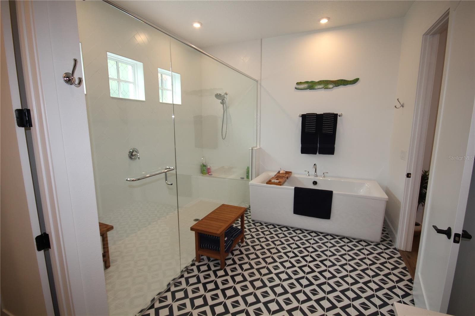WALK-IN SHOWER WITH BUILT-IN BENCH AND FREESTANDING SOAKING TUB - 1859 BEACH RIDGE RD, CELEBRATION