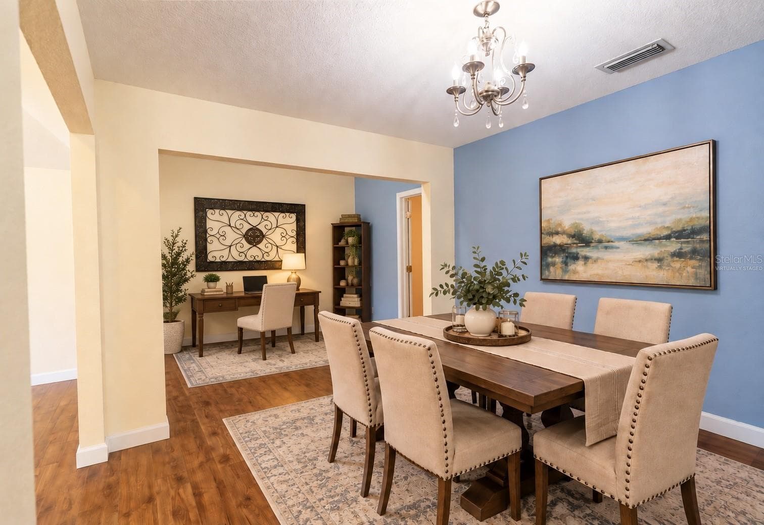 Virtually staged dining room showcasing the adjoining space as a home office - 4418 NE 4TH ST, OCALA