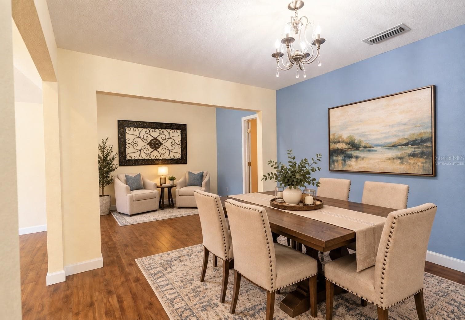Virtually staged dining room showcasing the adjoining space as a cozy reading and conversation area - 4418 NE 4TH ST, OCALA