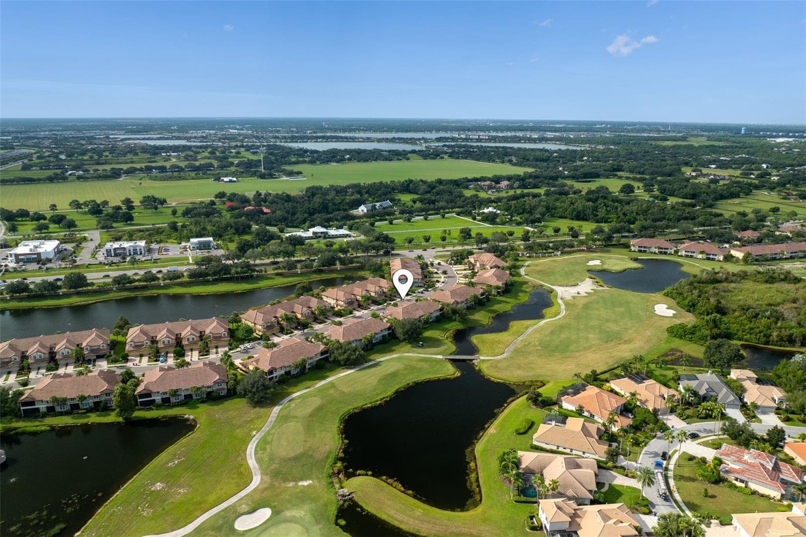 Set along Legacy Golf Course, this home enjoys sweeping fairway and lake views—a beautiful backdrop for morning coffee, quiet evenings, and relaxed Florida living. - 8432 MIRAMAR WAY, LAKEWOOD RANCH