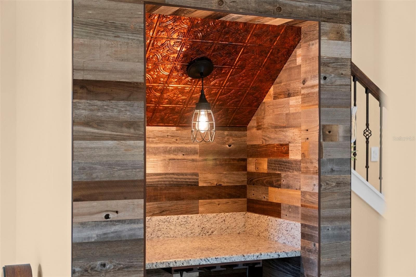 Wood accents, a decorative ceiling, and pendant lighting make this custom wine nook a conversation piece. - 8432 MIRAMAR WAY, LAKEWOOD RANCH