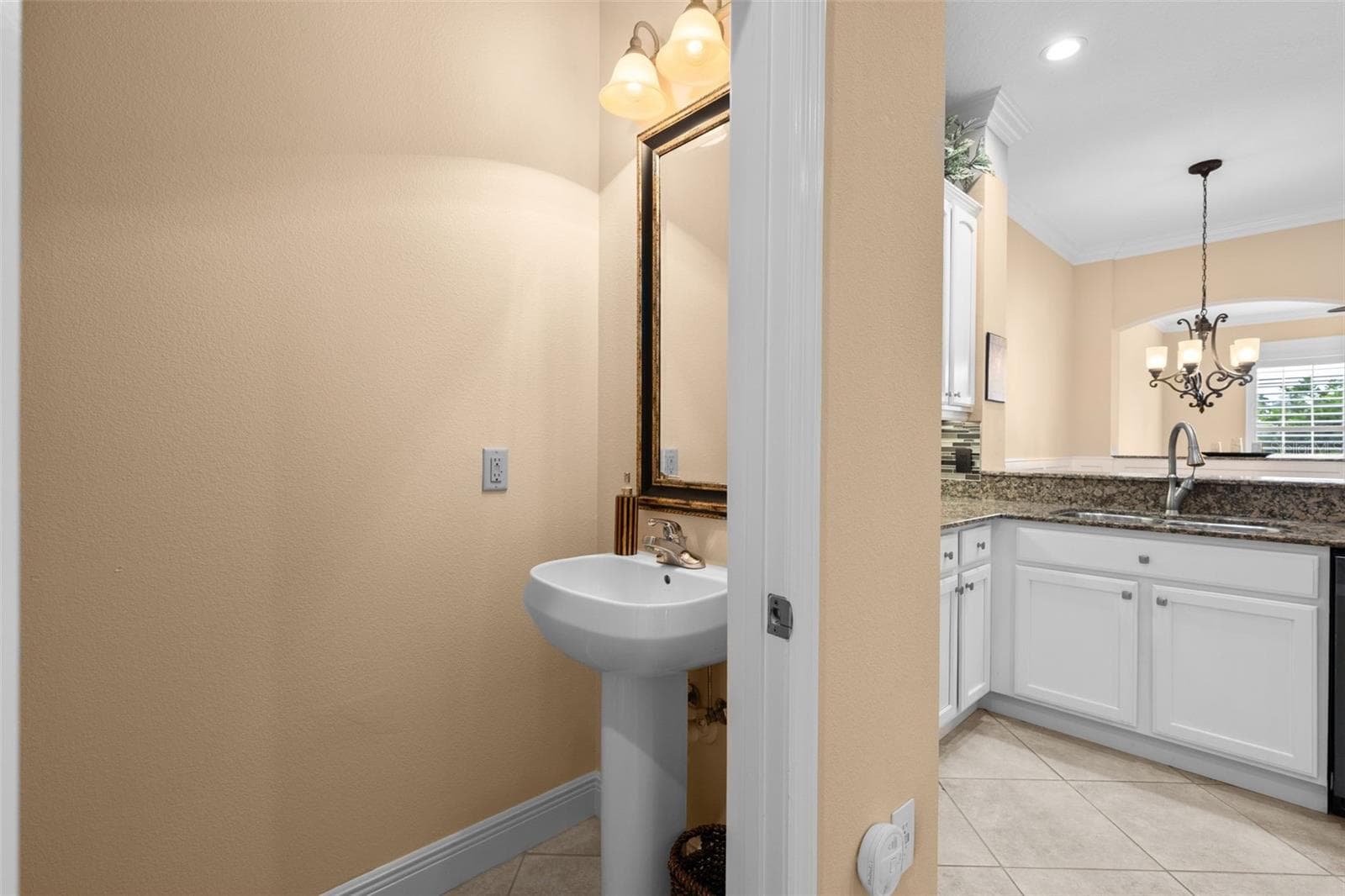 A conveniently located half bath just off the kitchen makes hosting guests easy. - 8432 MIRAMAR WAY, LAKEWOOD RANCH