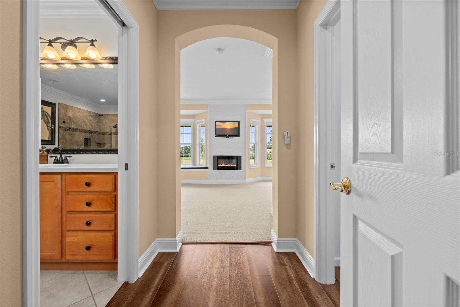 An arched entry leads into the primary retreat, with the ensuite bath close at hand. - 8432 MIRAMAR WAY, LAKEWOOD RANCH