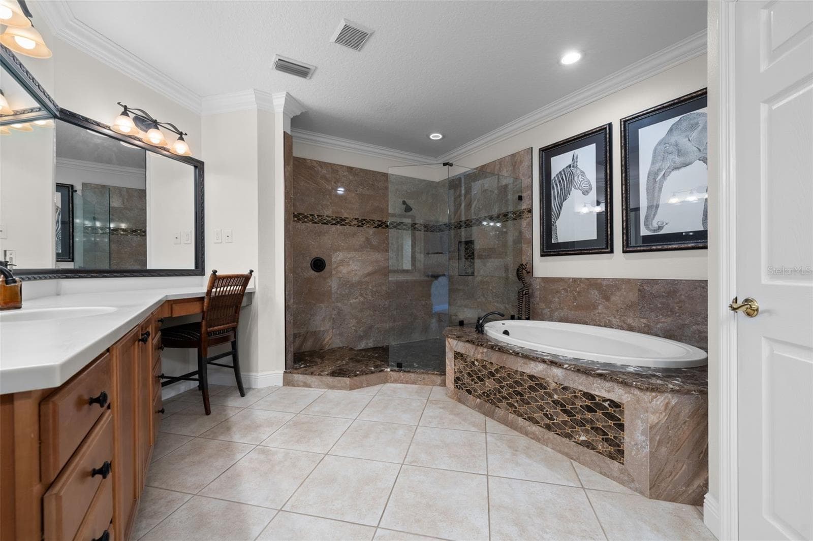 A spacious retreat with a soaking tub, glass-enclosed shower, and plenty of room to get ready. - 8432 MIRAMAR WAY, LAKEWOOD RANCH
