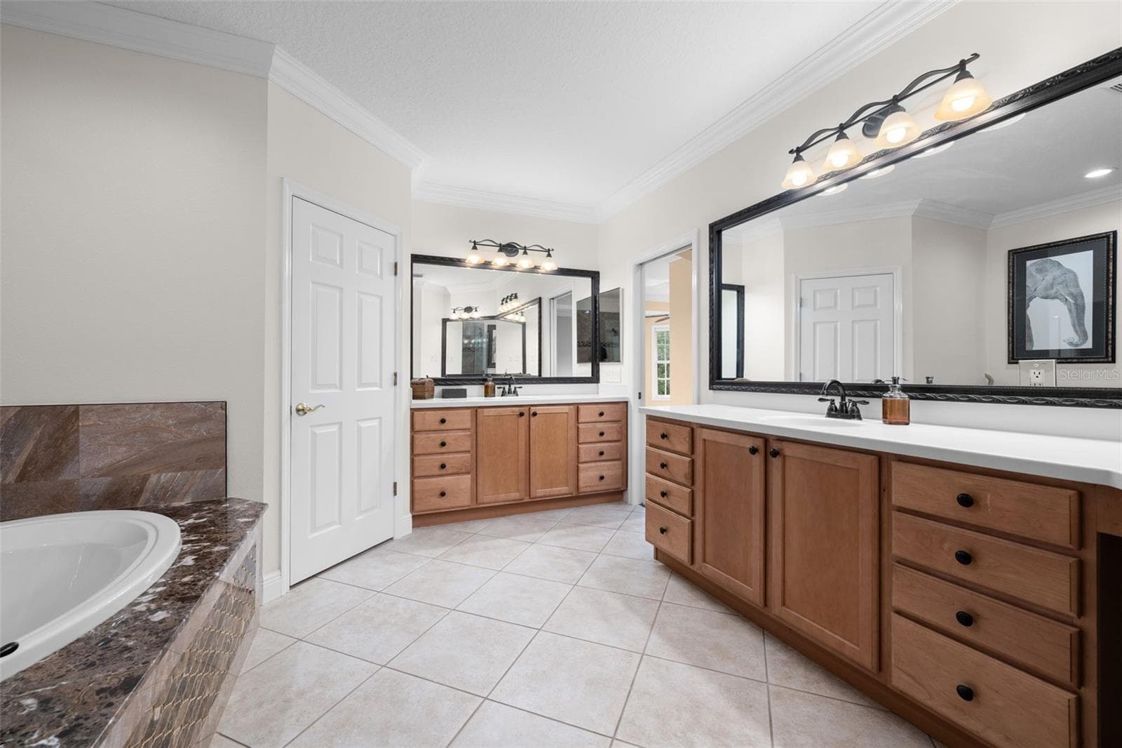 Separate vanities and abundant drawer space make sharing the primary bath easy. - 8432 MIRAMAR WAY, LAKEWOOD RANCH