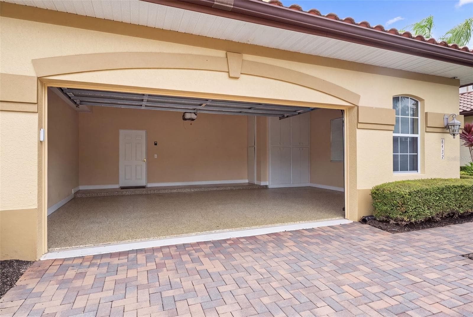 A spacious 28-by-22-foot garage offers room for two cars, a golf cart, and your Florida adventure gear. - 8432 MIRAMAR WAY, LAKEWOOD RANCH