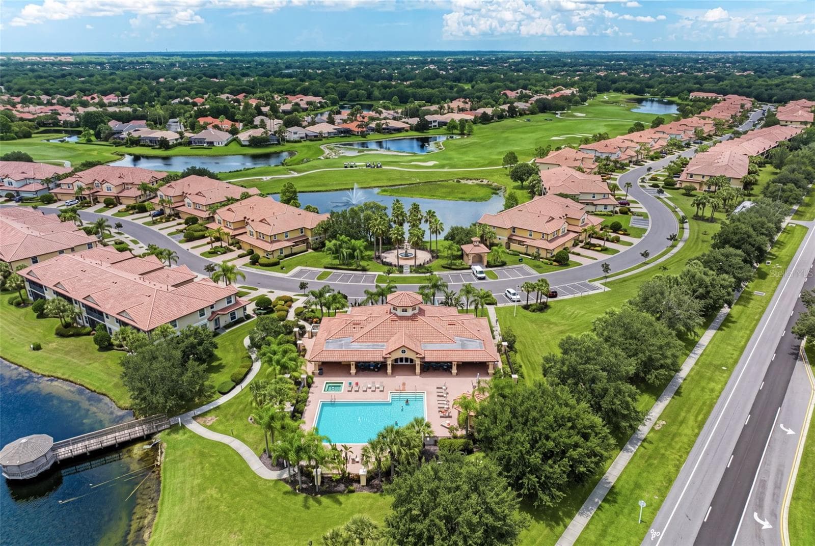 A beautiful aerial look at Miramar’s lakes, golf course surroundings, and community pool. - 8432 MIRAMAR WAY, LAKEWOOD RANCH