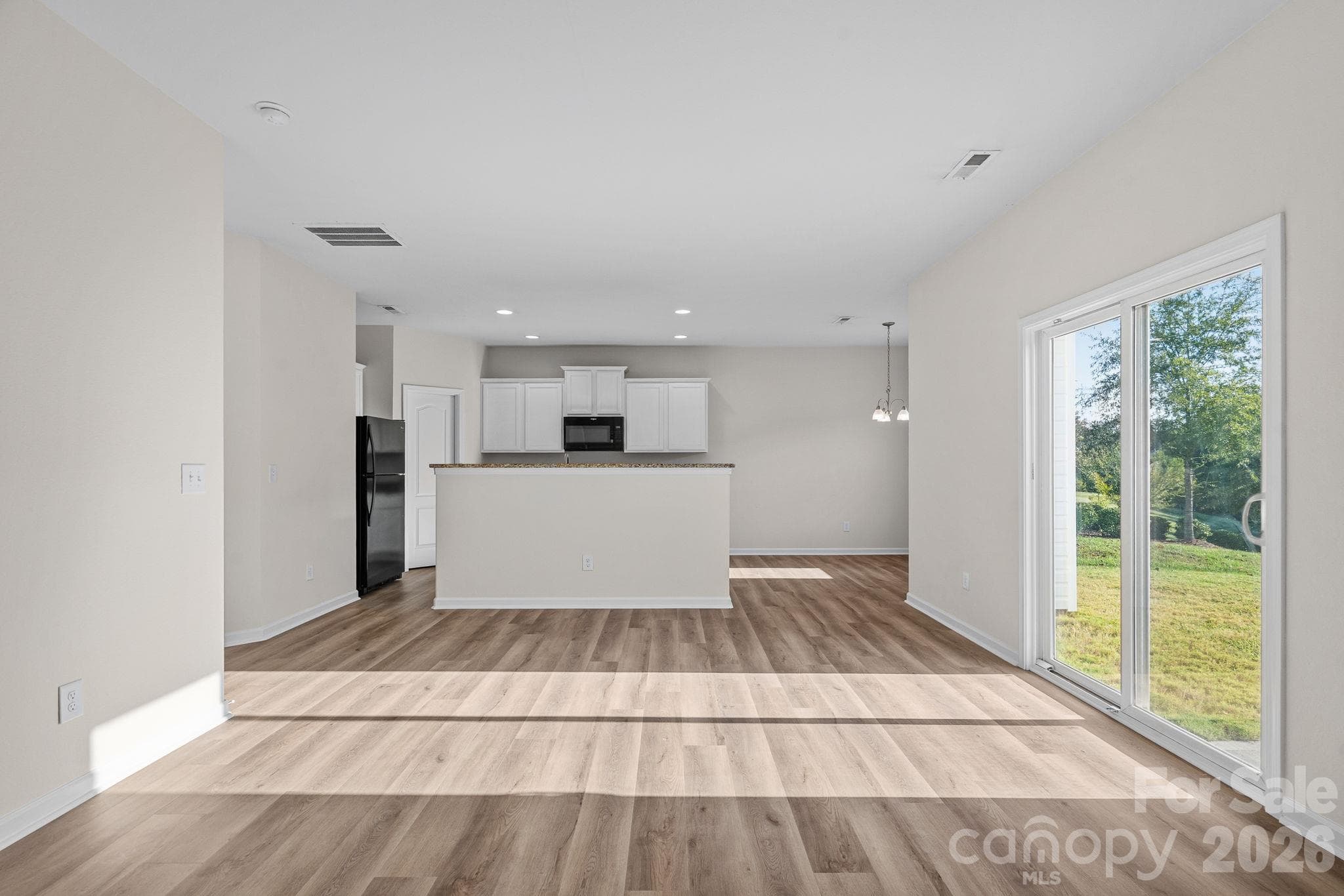 Dining and kitchen without virtual staging - 6215 Paw Village Road, Charlotte