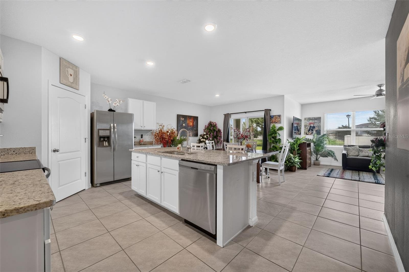 Open floor plan featuring a spacious kitchen, dining area, and living room. - 4367 LOOKING GLASS PL, SANFORD
