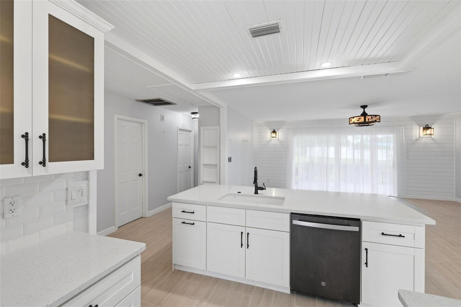 The opposite side of breakfast bar shows the sink, dishwasher and extra storage cabinetry. - 4 ANTIGUA CIR #6, ENGLEWOOD