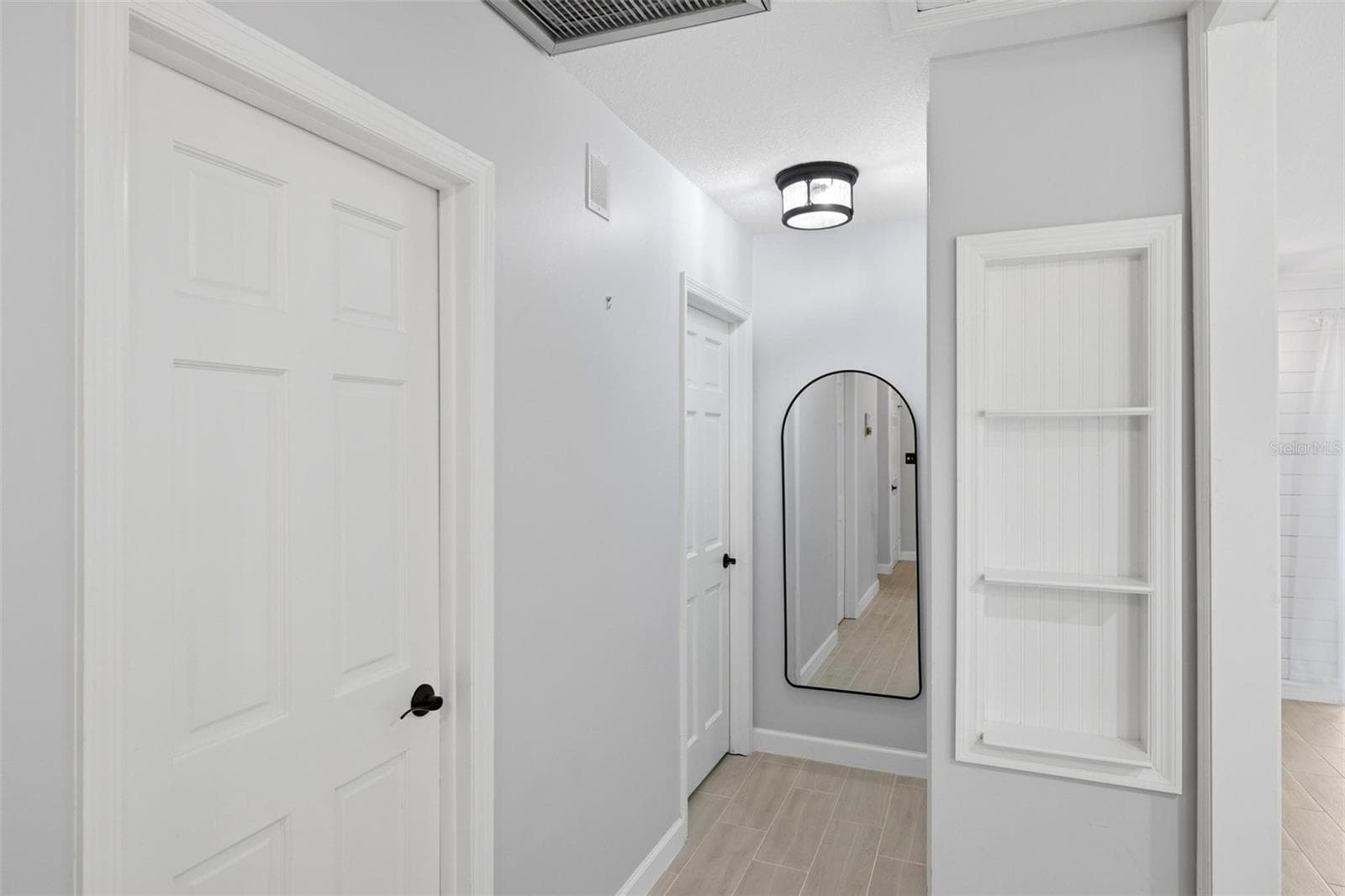 the hallway to the bedroom area. Full length mirror for that double check before you leave the home. A built in shelving unit for displaying favorite items. - 4 ANTIGUA CIR #6, ENGLEWOOD