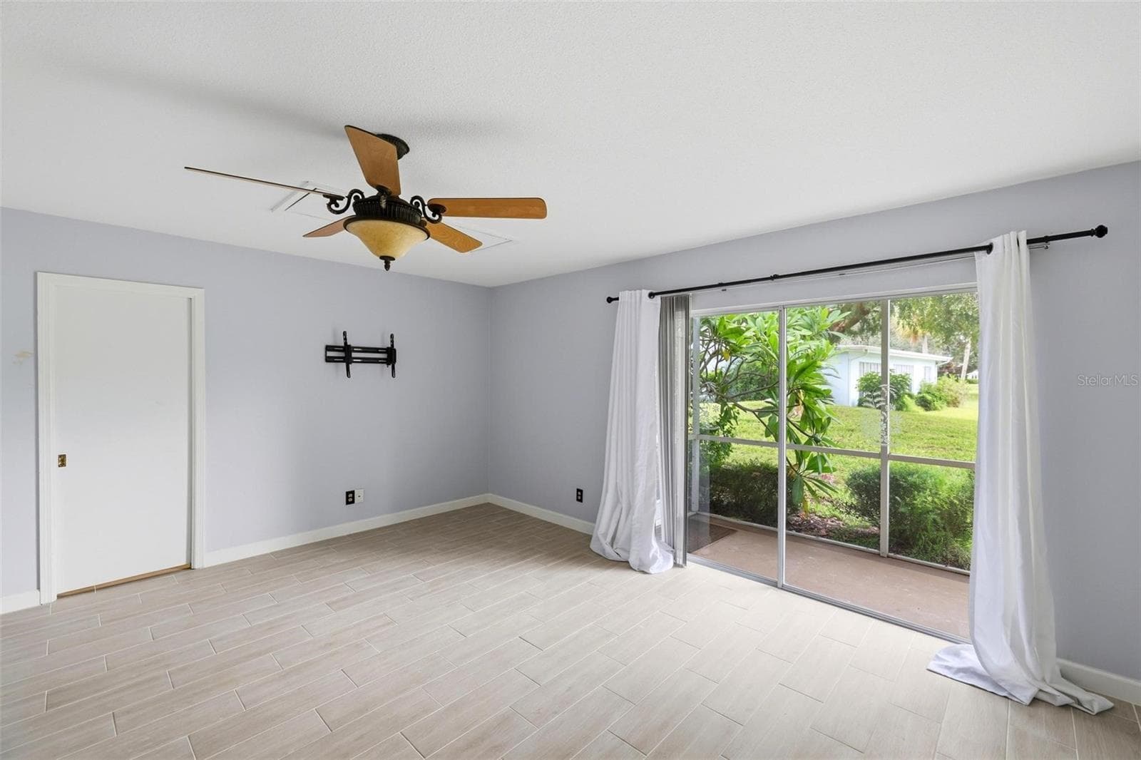 View from primary bedroom into lanai and rear yard. - 4 ANTIGUA CIR #6, ENGLEWOOD
