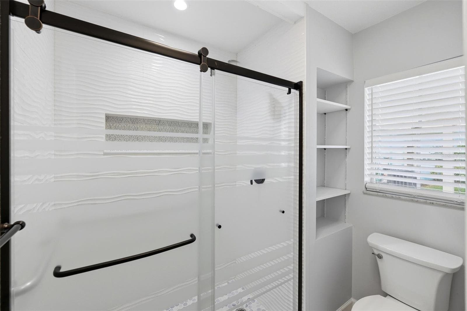 Another view of the primary bath shower and toilet area along with window for light and bright! - 4 ANTIGUA CIR #6, ENGLEWOOD