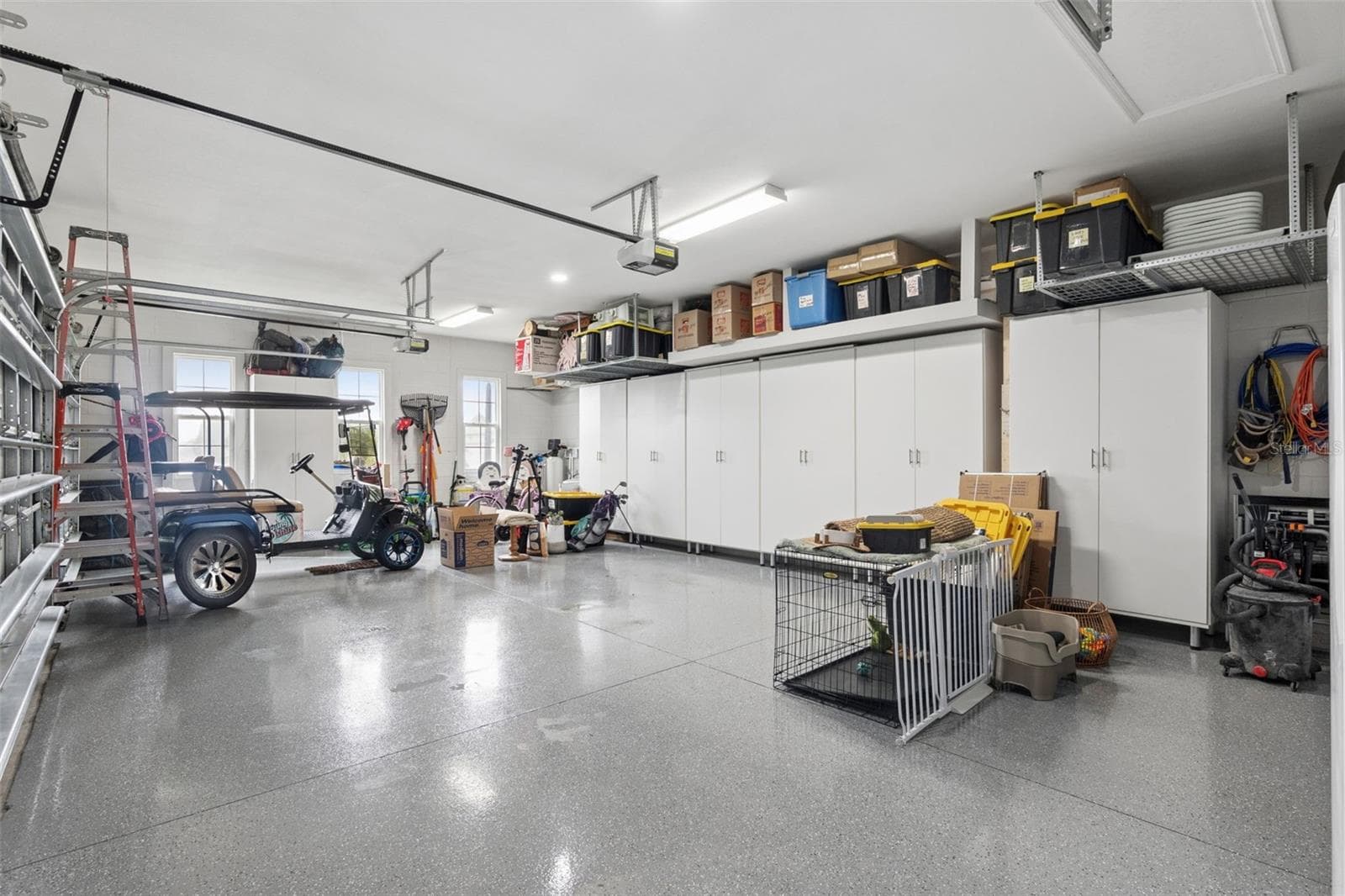 3 car garage with cabinets and tool bench epoxy floors - 8400 BRIDGEPORT BAY CIR, MOUNT DORA
