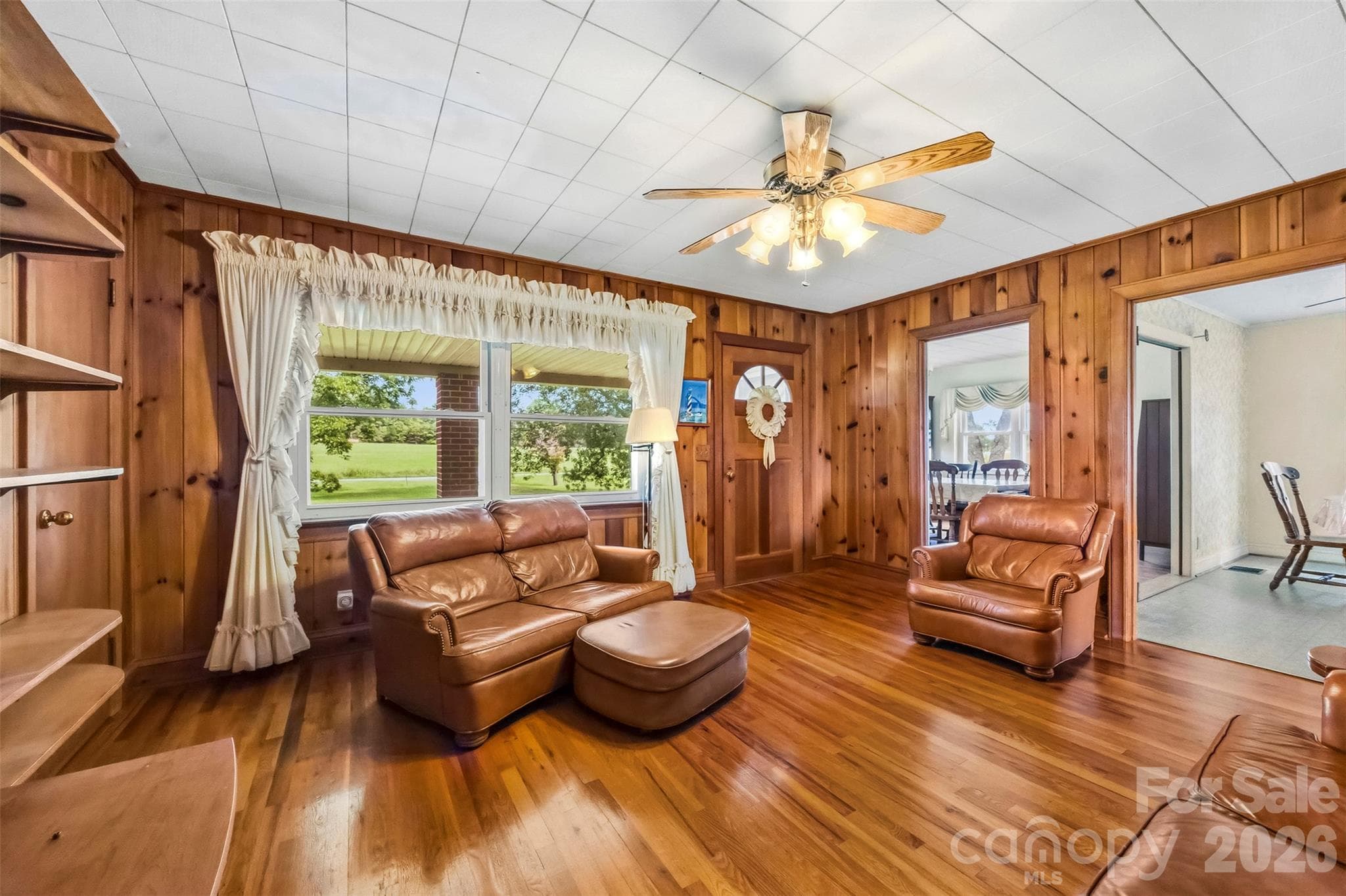 The main entrance from the front porch leads to this warm living room.  There are openings to the dining room and kitchen/breakfast area. - 2925 Fallston Waco Road, Shelby