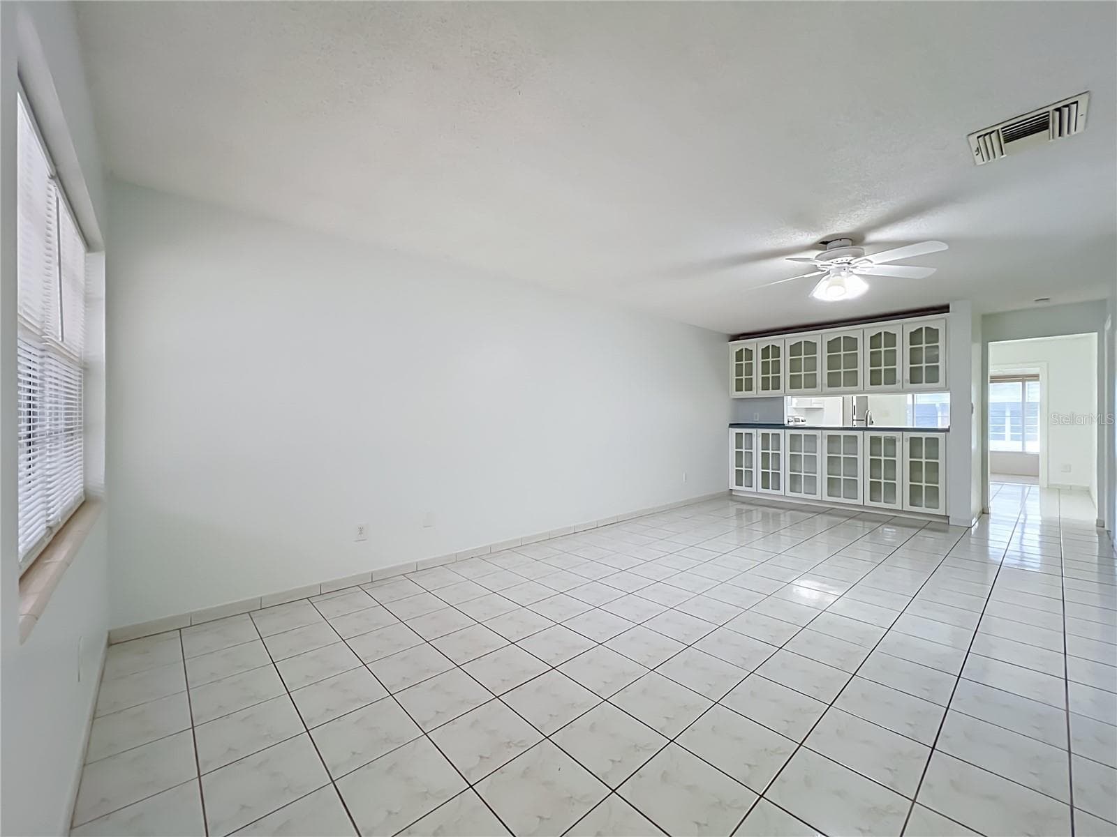 Bright and spacious living area with easy-to-maintain ceramic tile flooring. - 1225 CARRIAGE LN #1, ORLANDO