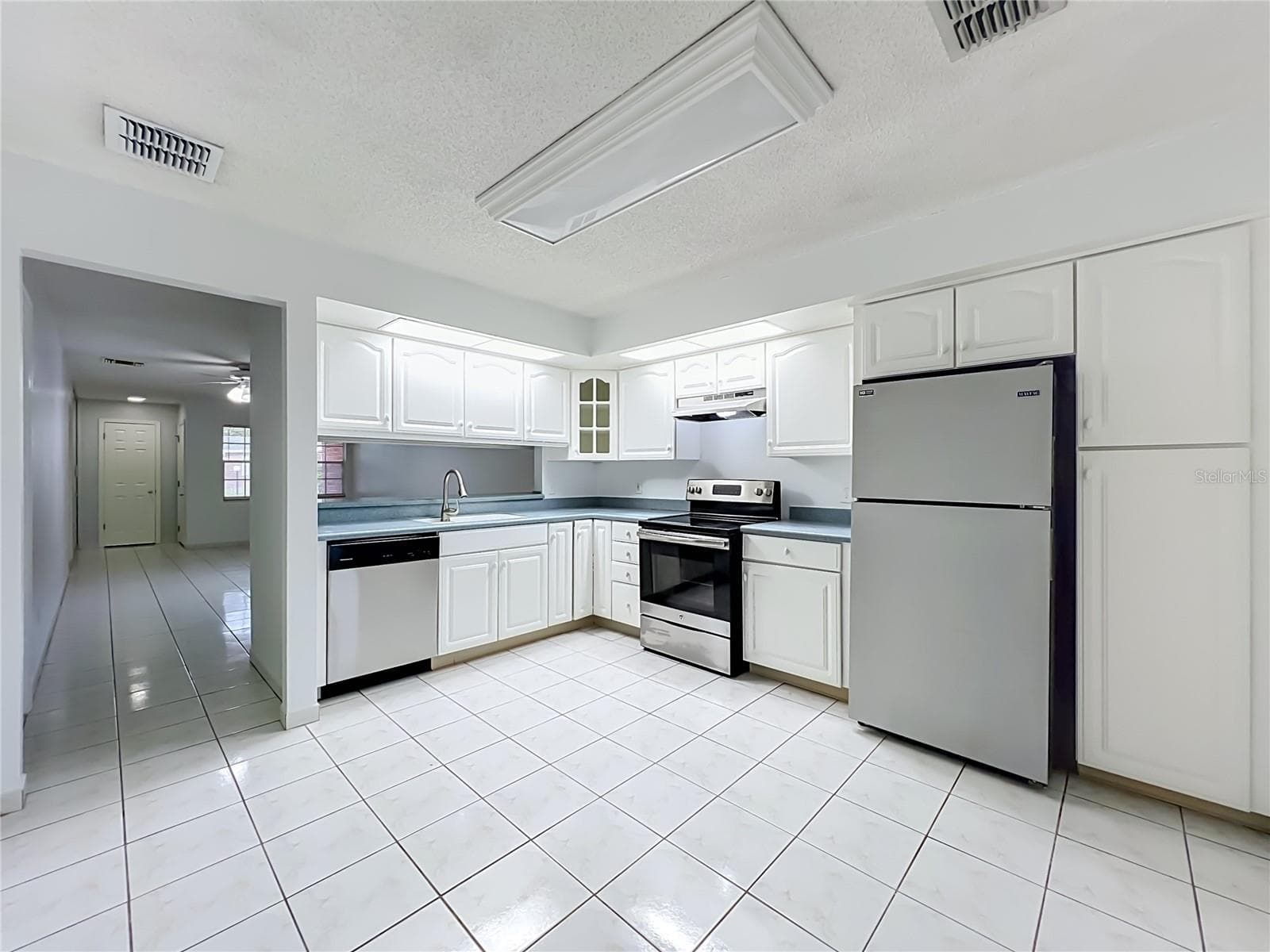 Spacious kitchen with plenty of cabinet and countertop space for everyday living. - 1225 CARRIAGE LN #1, ORLANDO