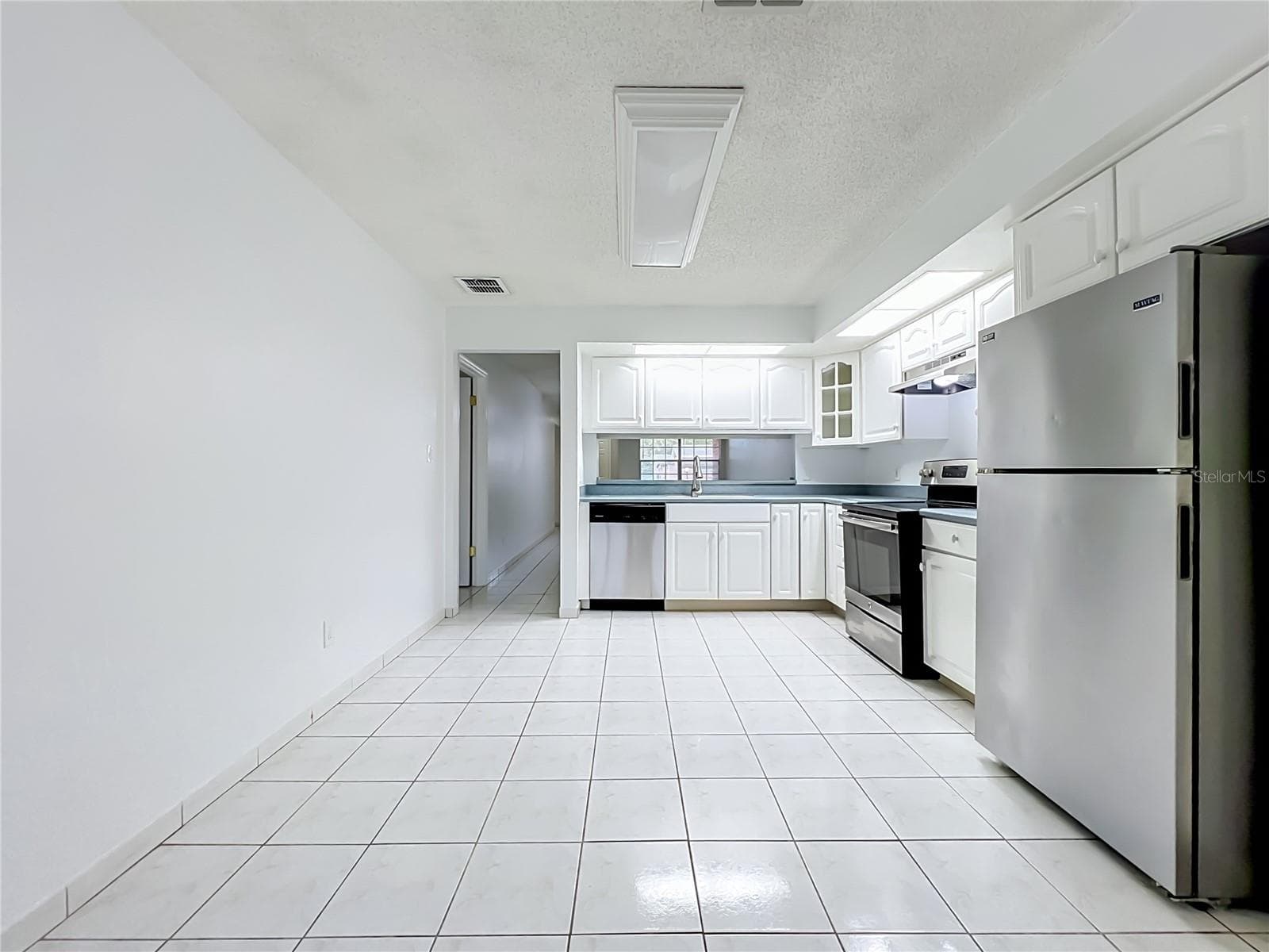Kitchen offers additional space for a breakfast or dining area. - 1225 CARRIAGE LN #1, ORLANDO