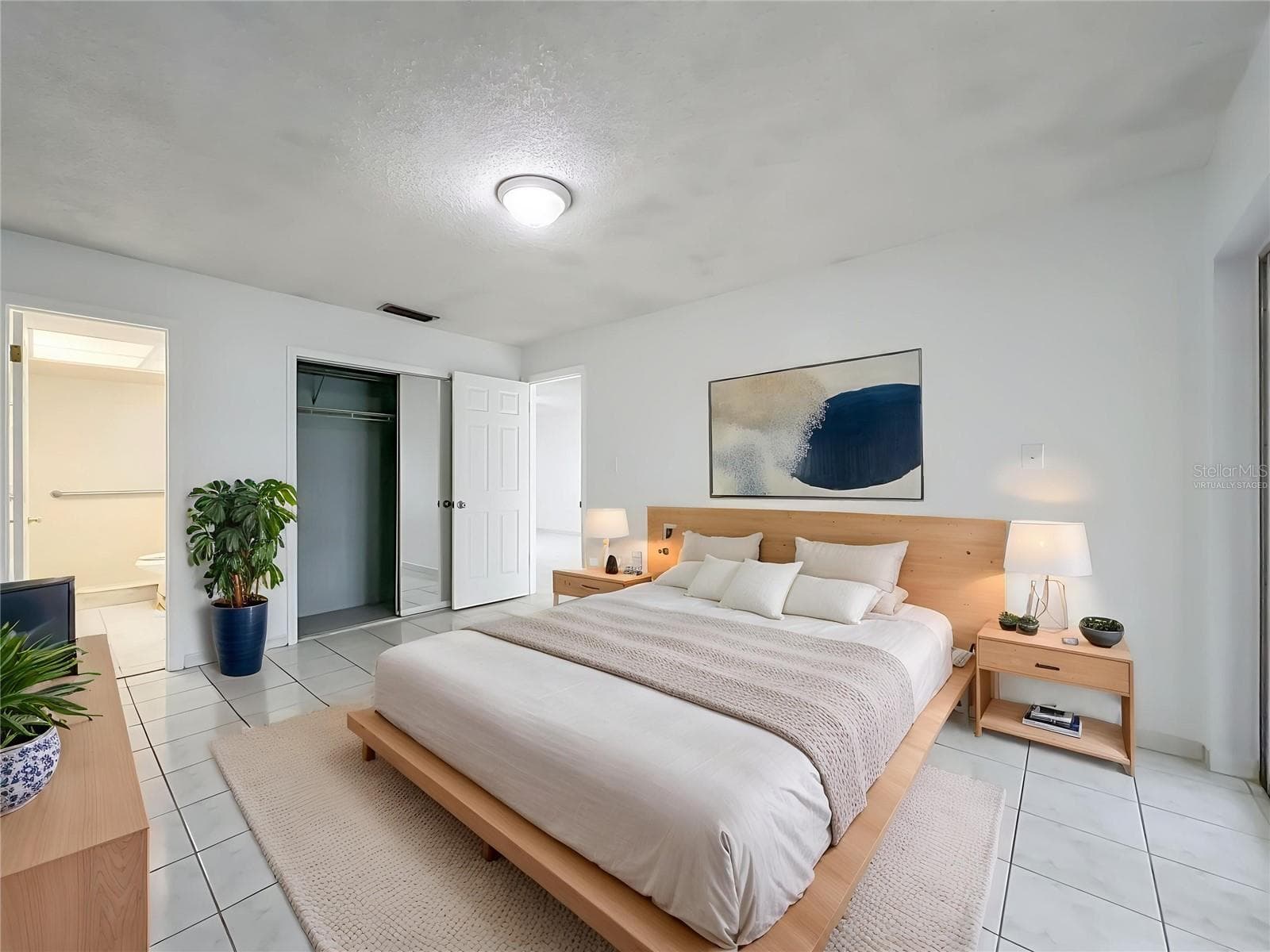 Virtually staged primary bedroom showcasing the generous room size and possibilities. - 1225 CARRIAGE LN #1, ORLANDO