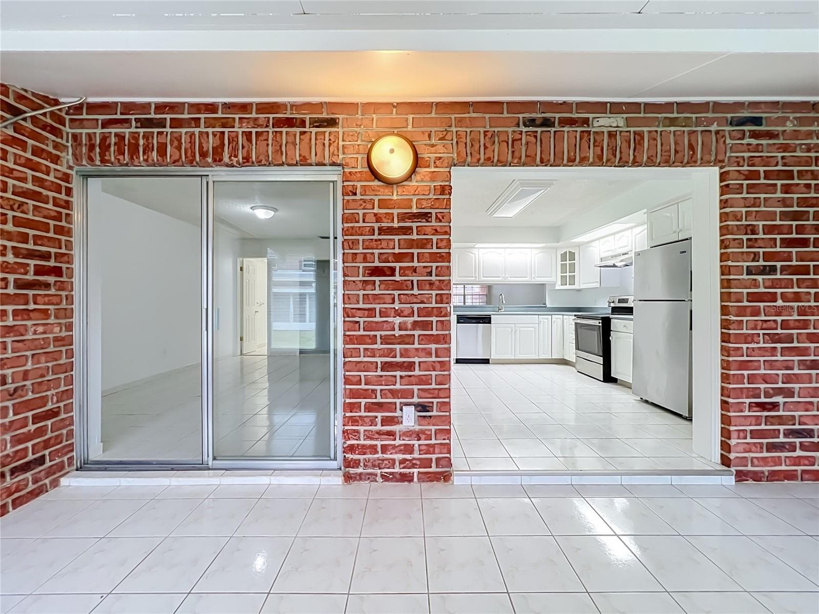 Florida room connects conveniently to the main living area and kitchen. - 1225 CARRIAGE LN #1, ORLANDO