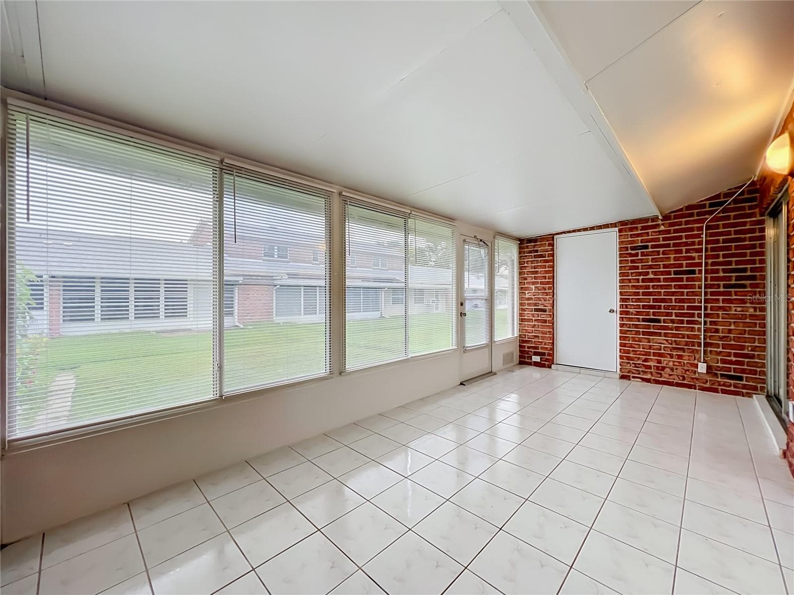 Florida room connects conveniently to the main living area and kitchen. - 1225 CARRIAGE LN #1, ORLANDO