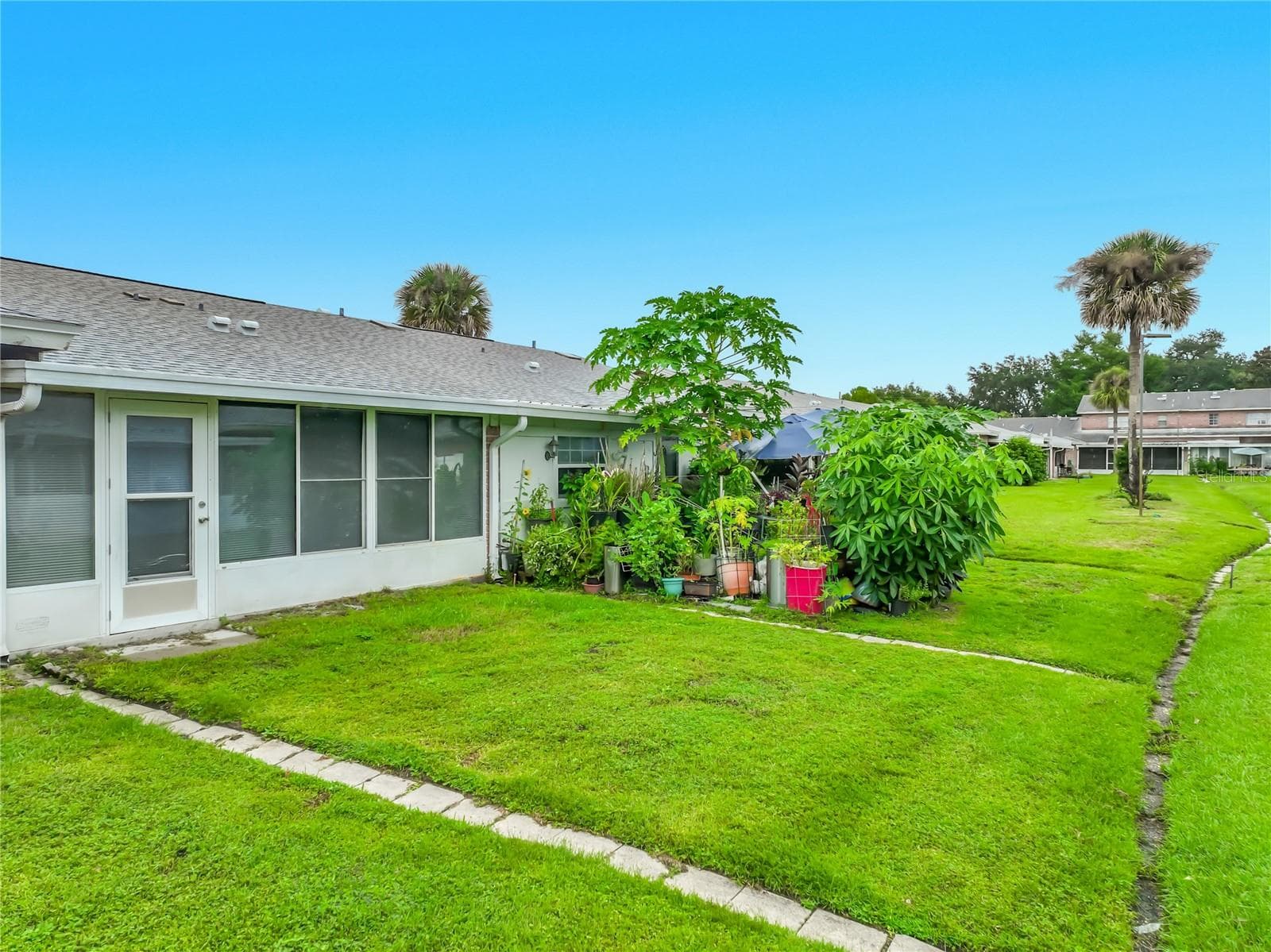 Green space just outside the home adds to the open and peaceful setting. - 1225 CARRIAGE LN #1, ORLANDO