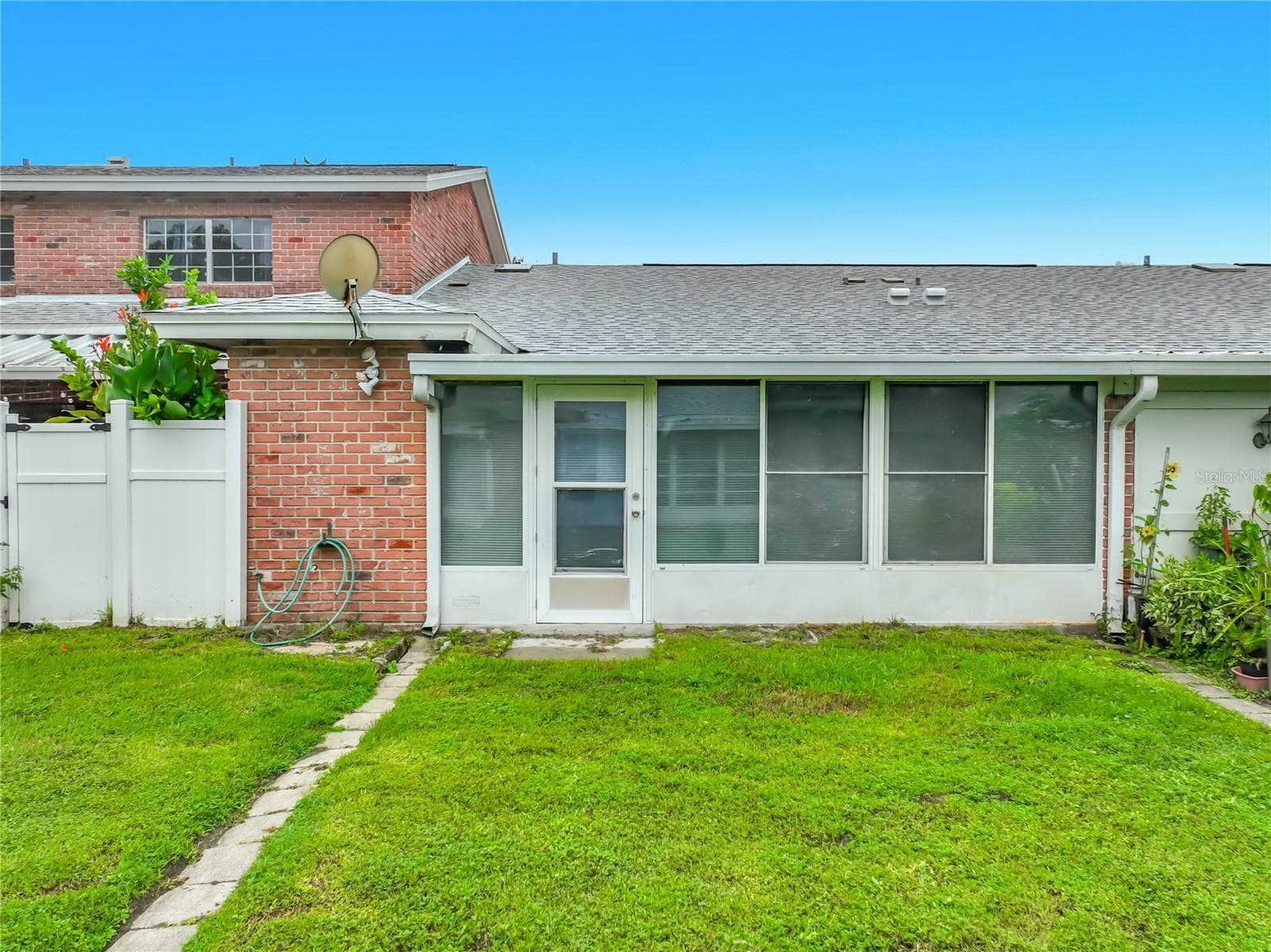 Rear exterior view of this charming one-story home. - 1225 CARRIAGE LN #1, ORLANDO