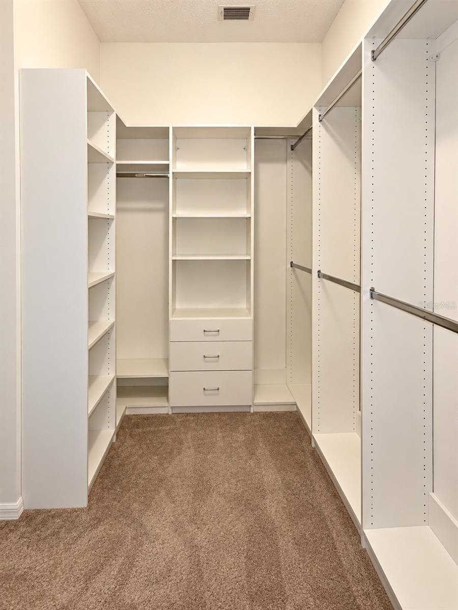 Primary bedroom closet with 'Closet by Design' built ins - 8543 SW AVIARY RD, ARCADIA